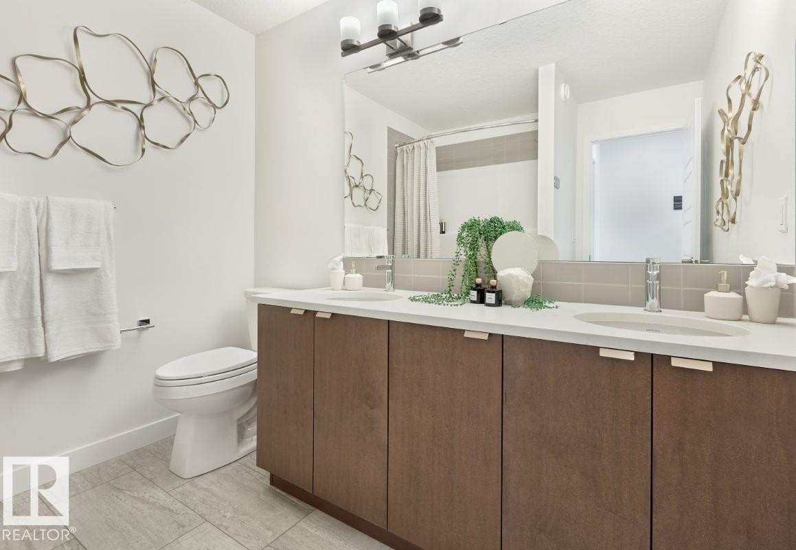 Bathroom with double vanity and curtained shower - 2131 194 Street Nw, Edmonton, AB - Indoor Photo Showing Bathroom