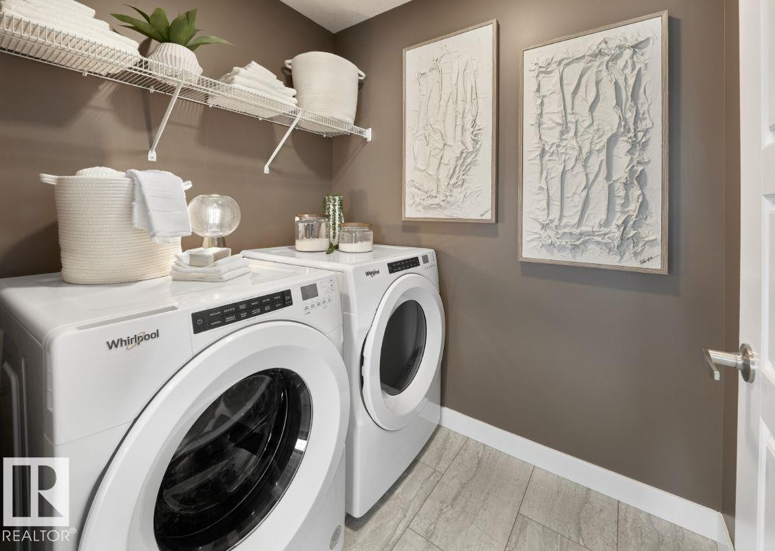 Laundry room with separate washer and dryer and baseboards - 2131 194 Street Nw, Edmonton, AB - Indoor Photo Showing Laundry Room