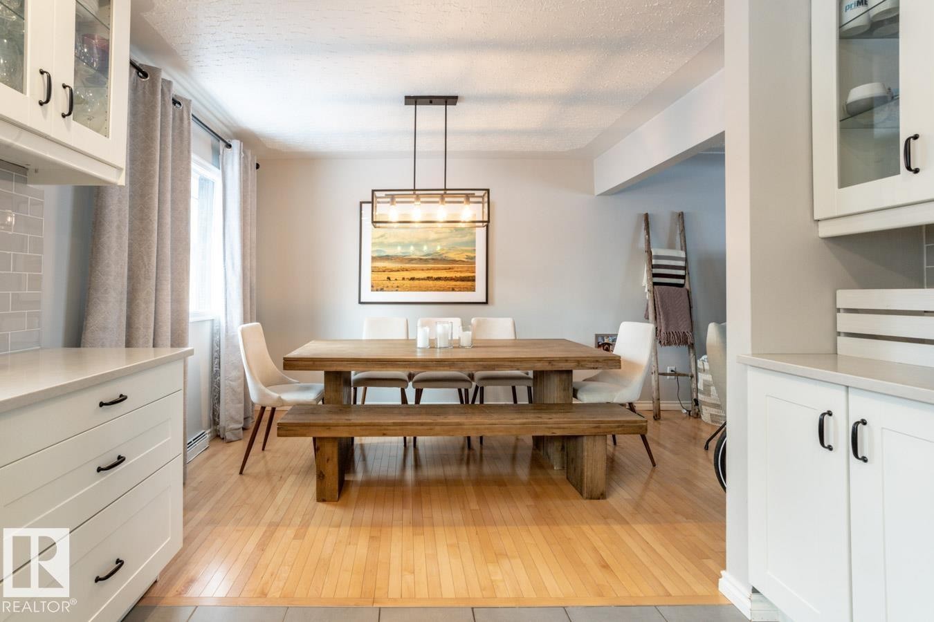 Wood-finish flooring featured throughout the dining area - 8239 93A Avenue, Edmonton, AB - Indoor Photo Showing Dining Room