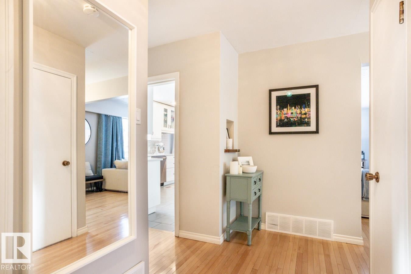 Hardwood flooring throughout entryway, featuring a built-in wall niche and white baseboards - 8239 93A Avenue, Edmonton, AB - Indoor Photo Showing Other Room