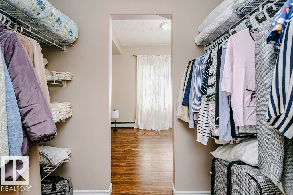 Walk-in closet featuring wire shelving and hanging rods - 323 16807 100 Avenue, Edmonton, AB - Indoor With Storage