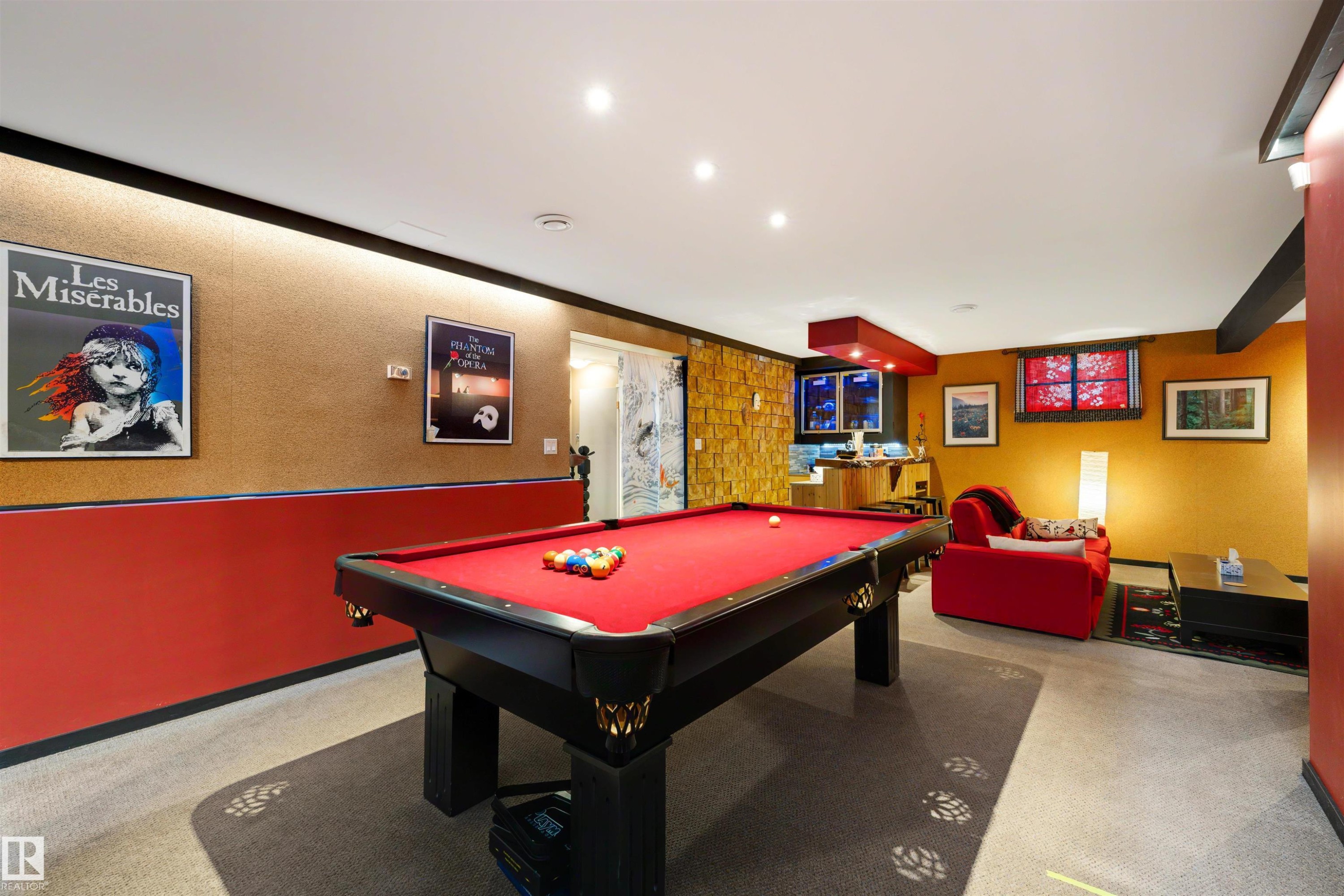 Recreation room featuring a full-size billiard table with a red felt surface, recessed lighting, and a textured accent wall - 9602 85 Street, Edmonton, AB