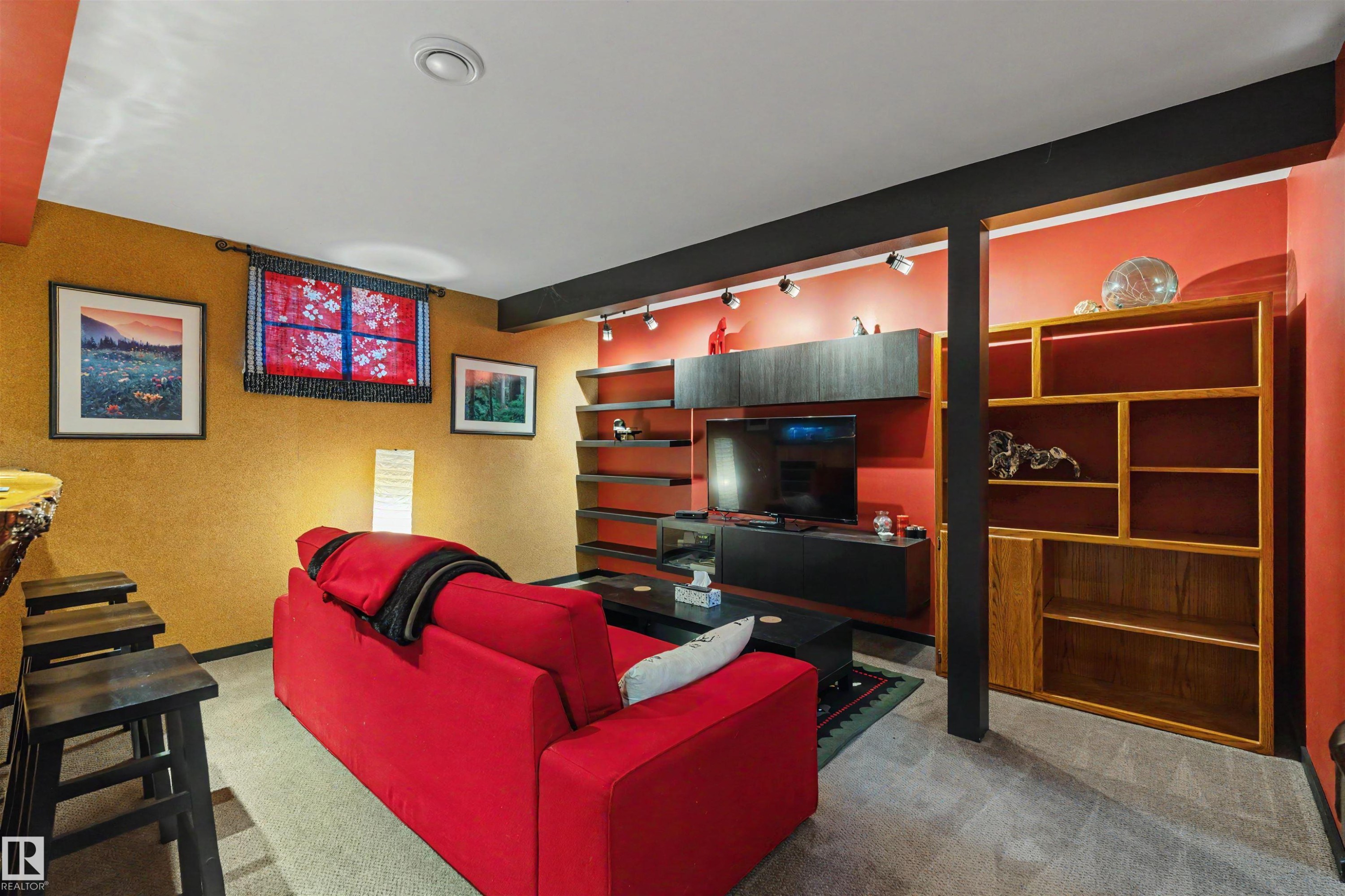 Recreational space featuring recessed lighting, track lighting, built-in shelving, a wood-finish bar, and textured wall finishes - 9602 85 Street, Edmonton, AB