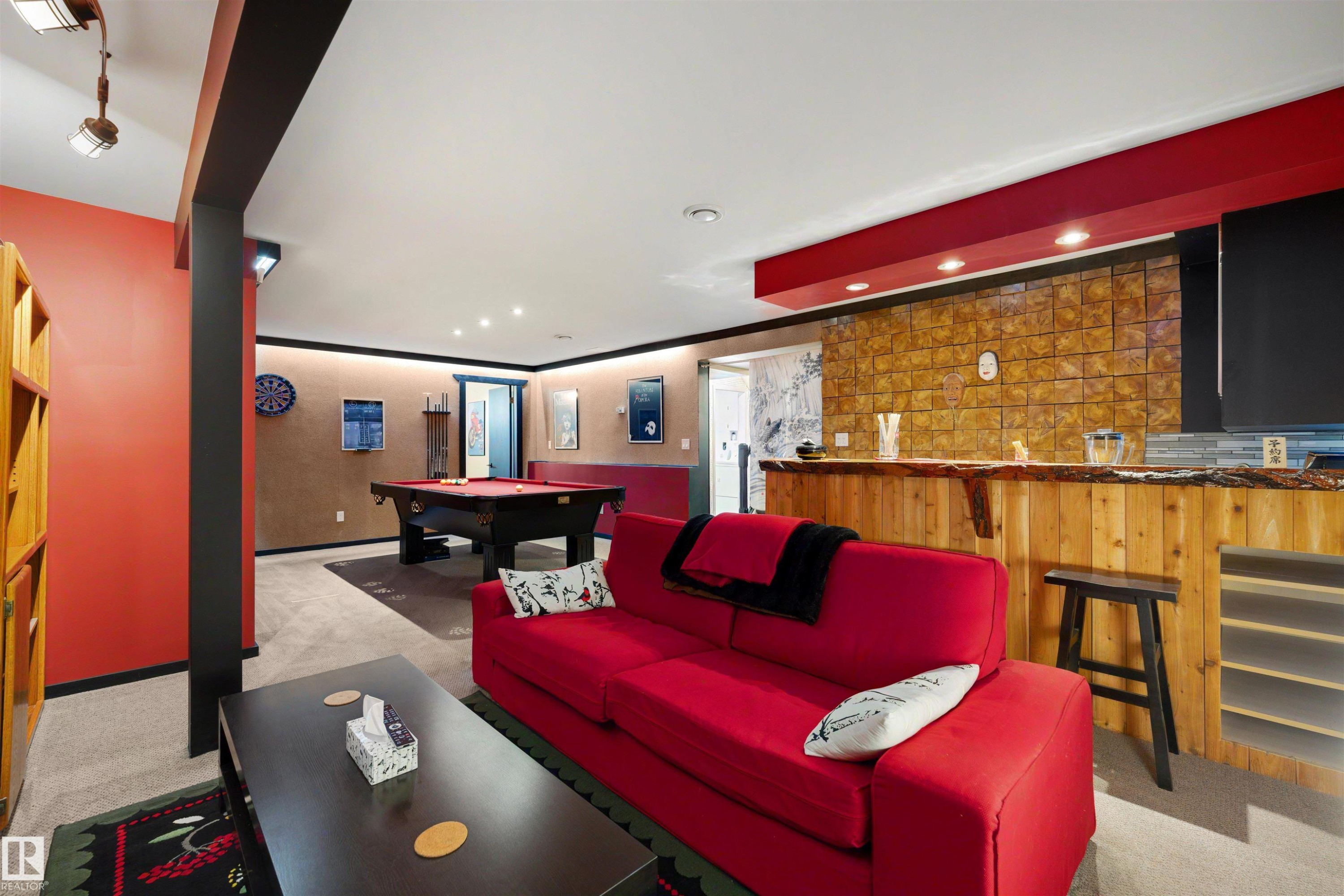 Spacious lower-level entertainment area featuring recessed lighting, a built-in bar with a stone veneer backsplash, wood-finish flooring, and a dedicated billiards zone - 9602 85 Street, Edmonton, AB