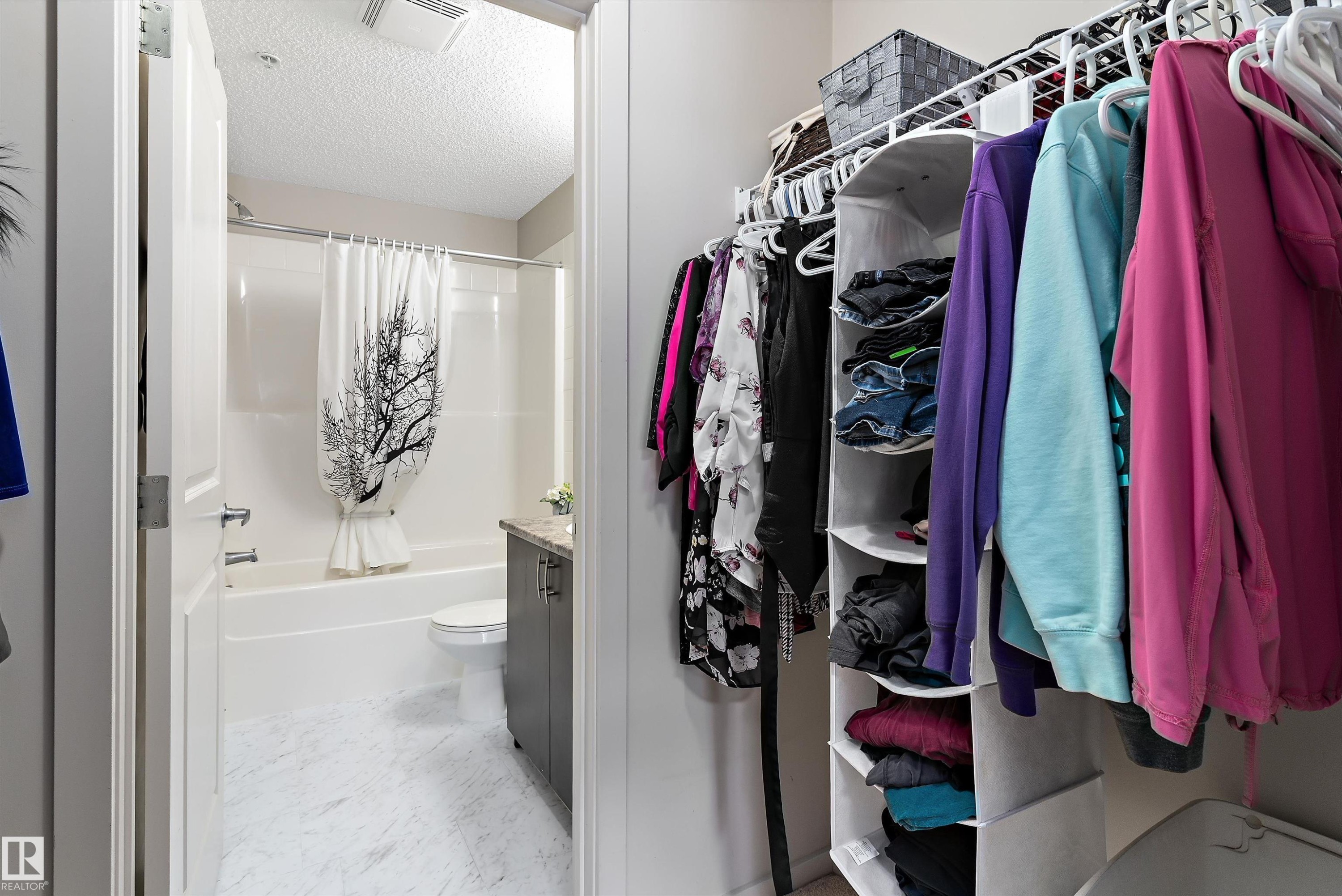 Bathroom featuring a combination shower and tub, tile flooring, and a vanity with a countertop - 231 344 Windermere Road, Edmonton, AB - Indoor With Storage