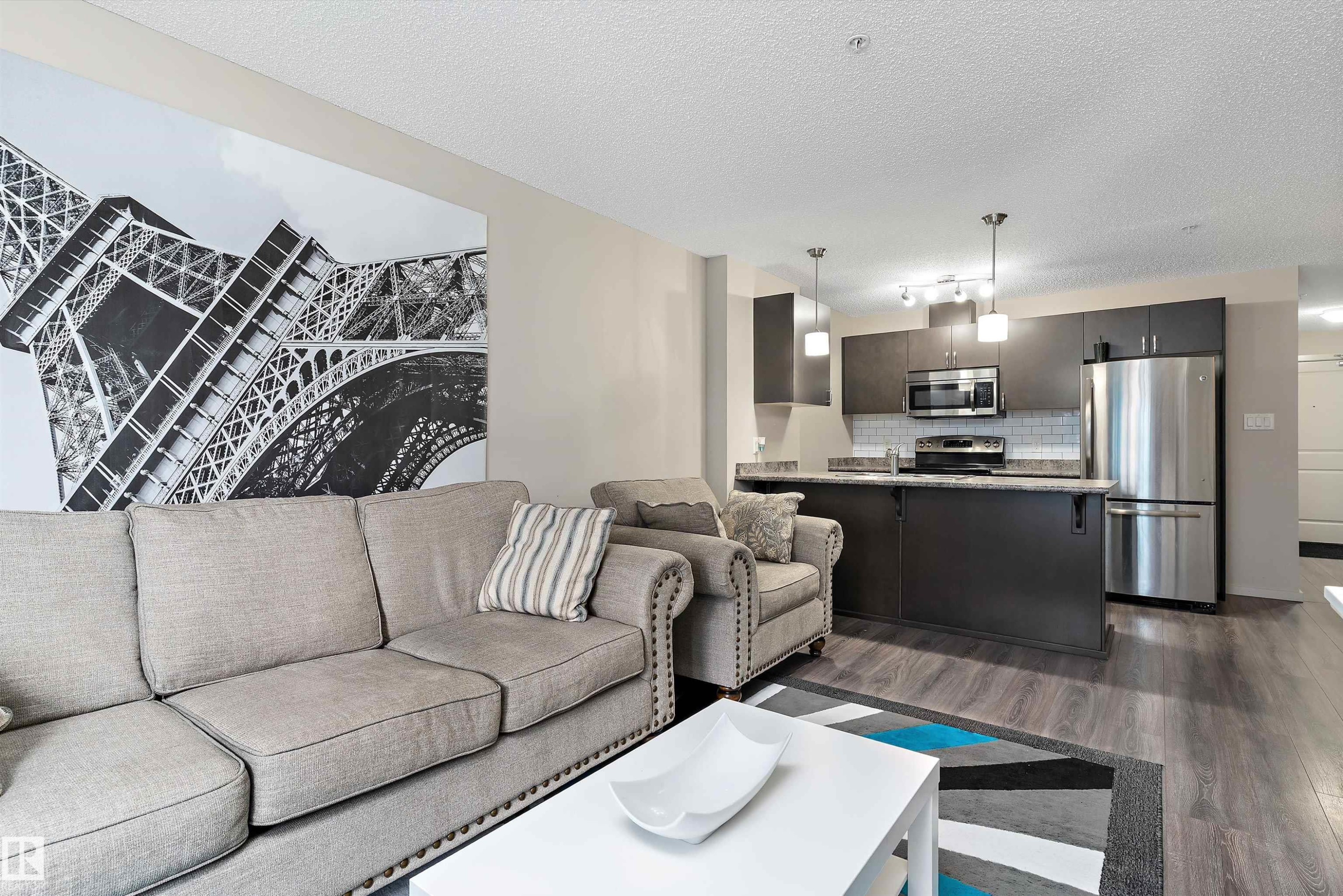Open-concept living space with dark wood-finish flooring - 231 344 Windermere Road, Edmonton, AB - Indoor