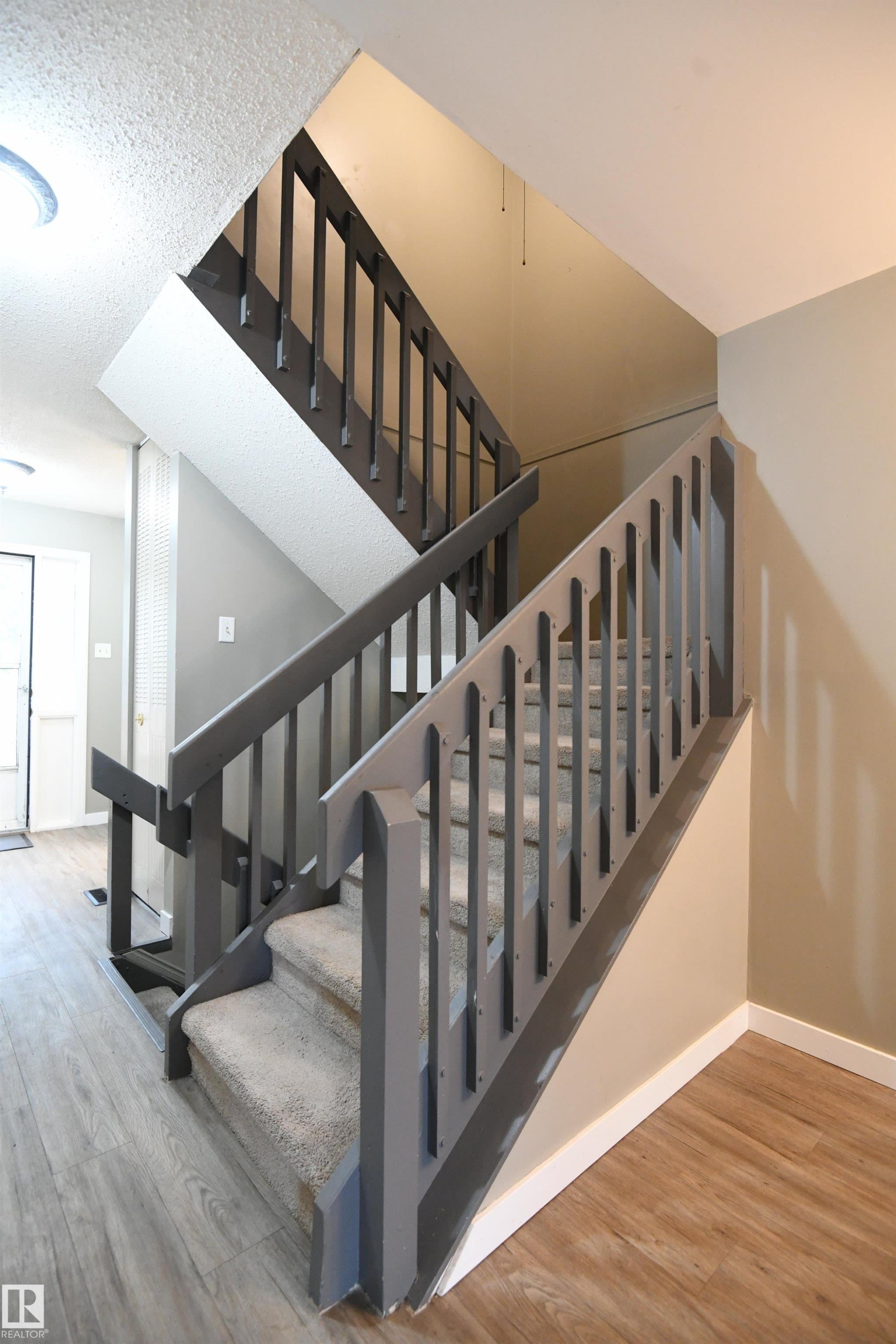 The open railings keep the space bright and flowing, and are also found on the second level, outside of the bedrooms - 6706 36A Avenue, Edmonton, AB - Indoor Photo Showing Other Room