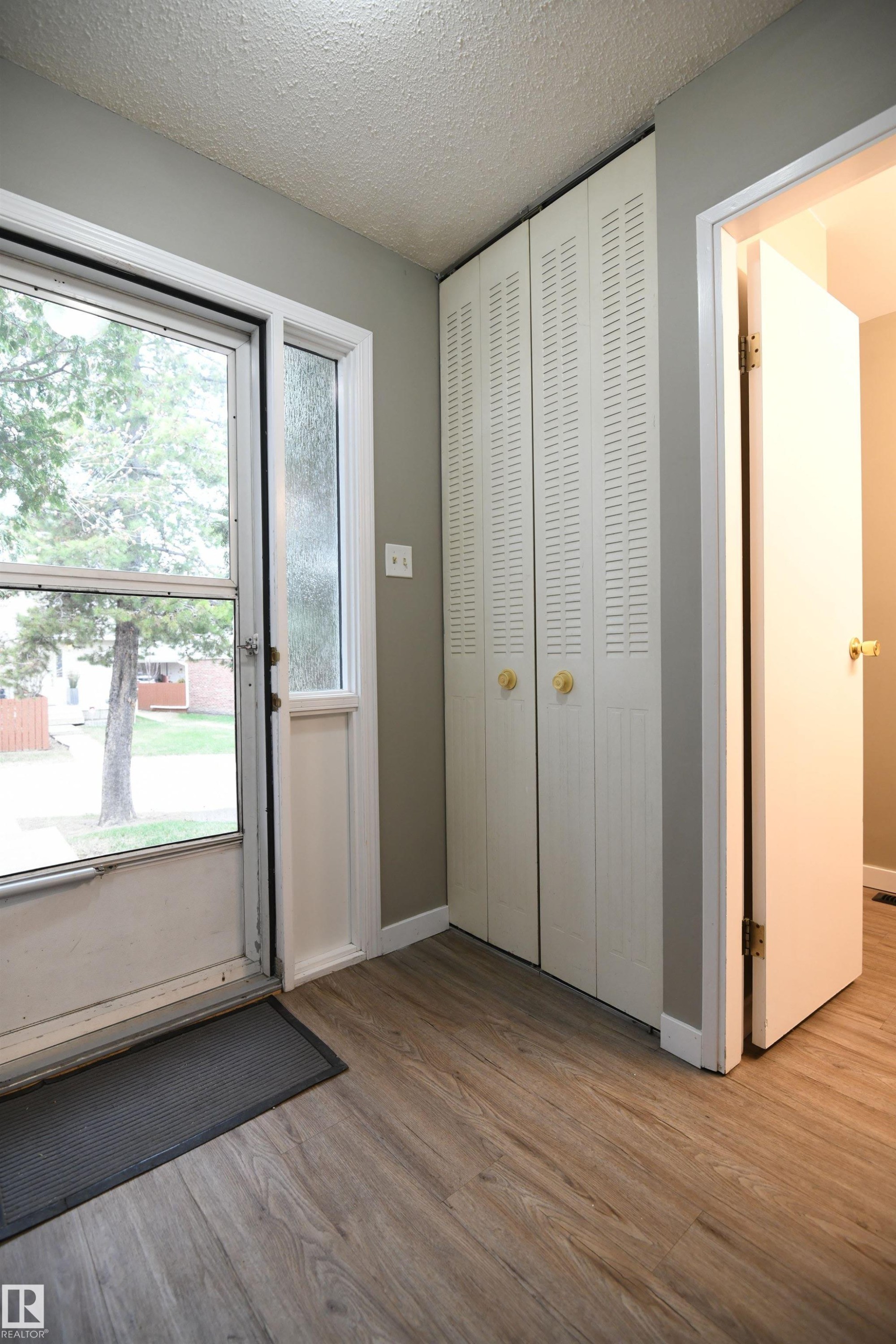 A proper front entrance keeps coats and shoes organized, and a floor to ceiling closet accentuates the sense of volume in the home. All 3 bedrooms also have the same tall closets - 6706 36A Avenue, Edmonton, AB - Indoor Photo Showing Other Room