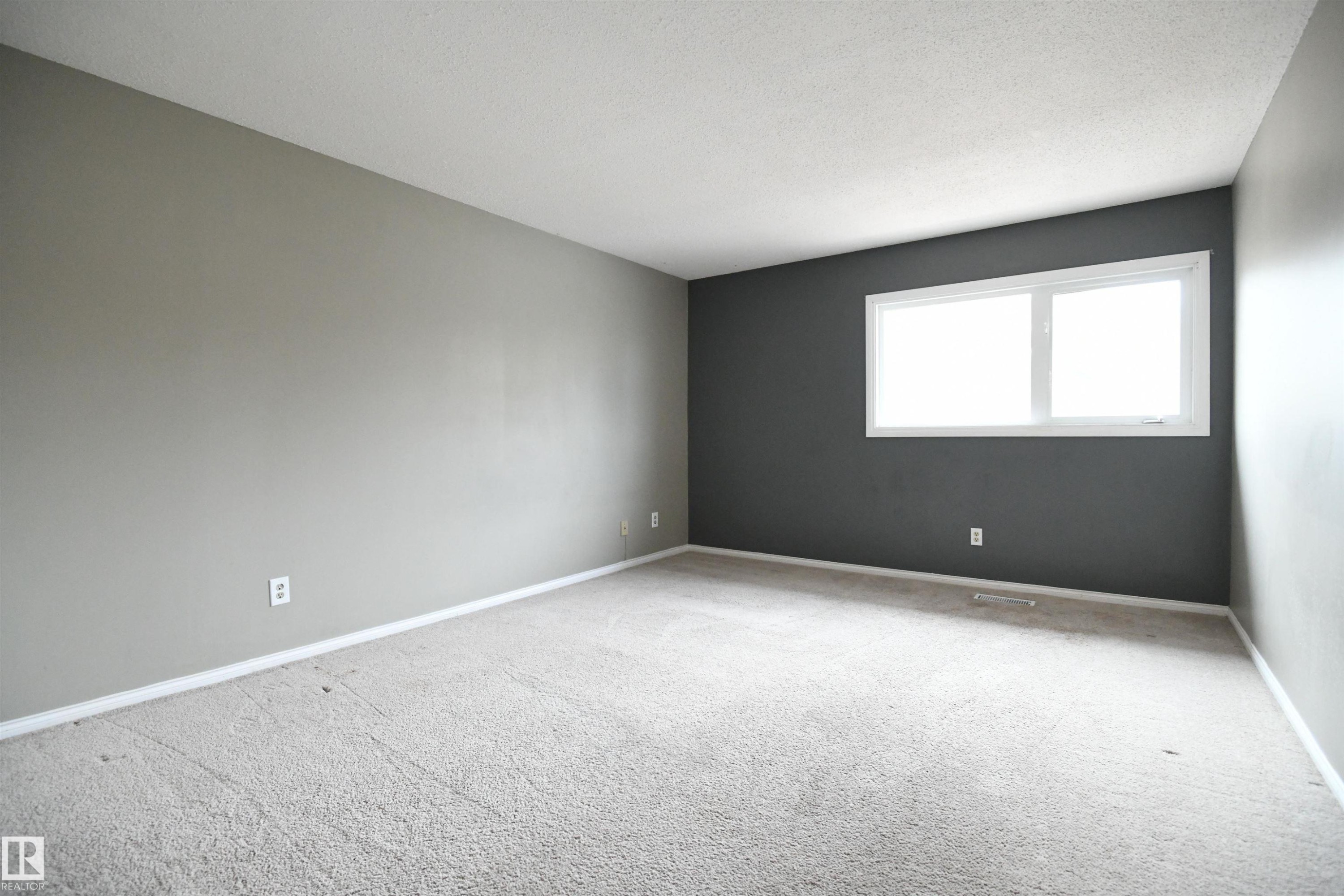 The master bedroom is cavernous and easily supports king sized furniture. Ample floor space and double, floor to ceiling closets give provide great storage. A second door from the master also serves the large 4 piece bathroom. Great privacy - 6706 36A Avenue, Edmonton, AB - Indoor Photo Showing Other Room