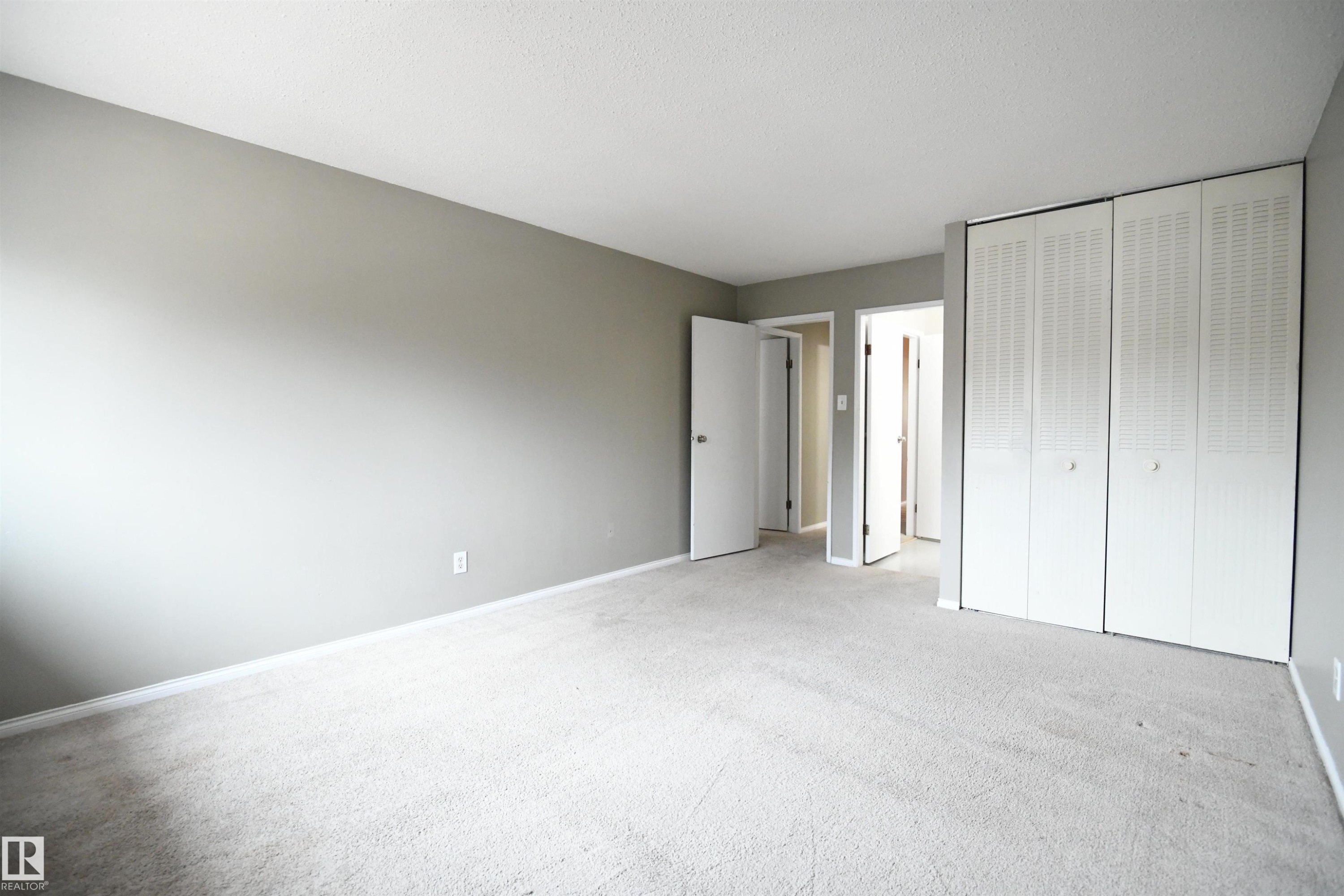The master bedroom is cavernous and easily supports king sized furniture. Ample floor space and double, floor to ceiling closets give provide great storage. A second door from the master also serves the large 4 piece bathroom. Great privacy - 6706 36A Avenue, Edmonton, AB - Indoor Photo Showing Other Room
