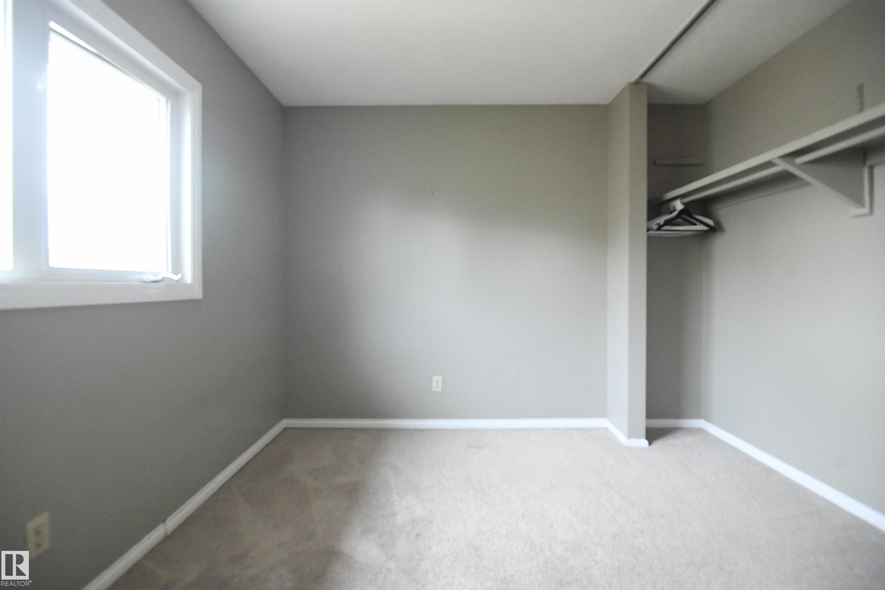 Both the second and third bedrooms are nicely sized, with generous closets. This one looks out the front of the unit - 6706 36A Avenue, Edmonton, AB - Indoor