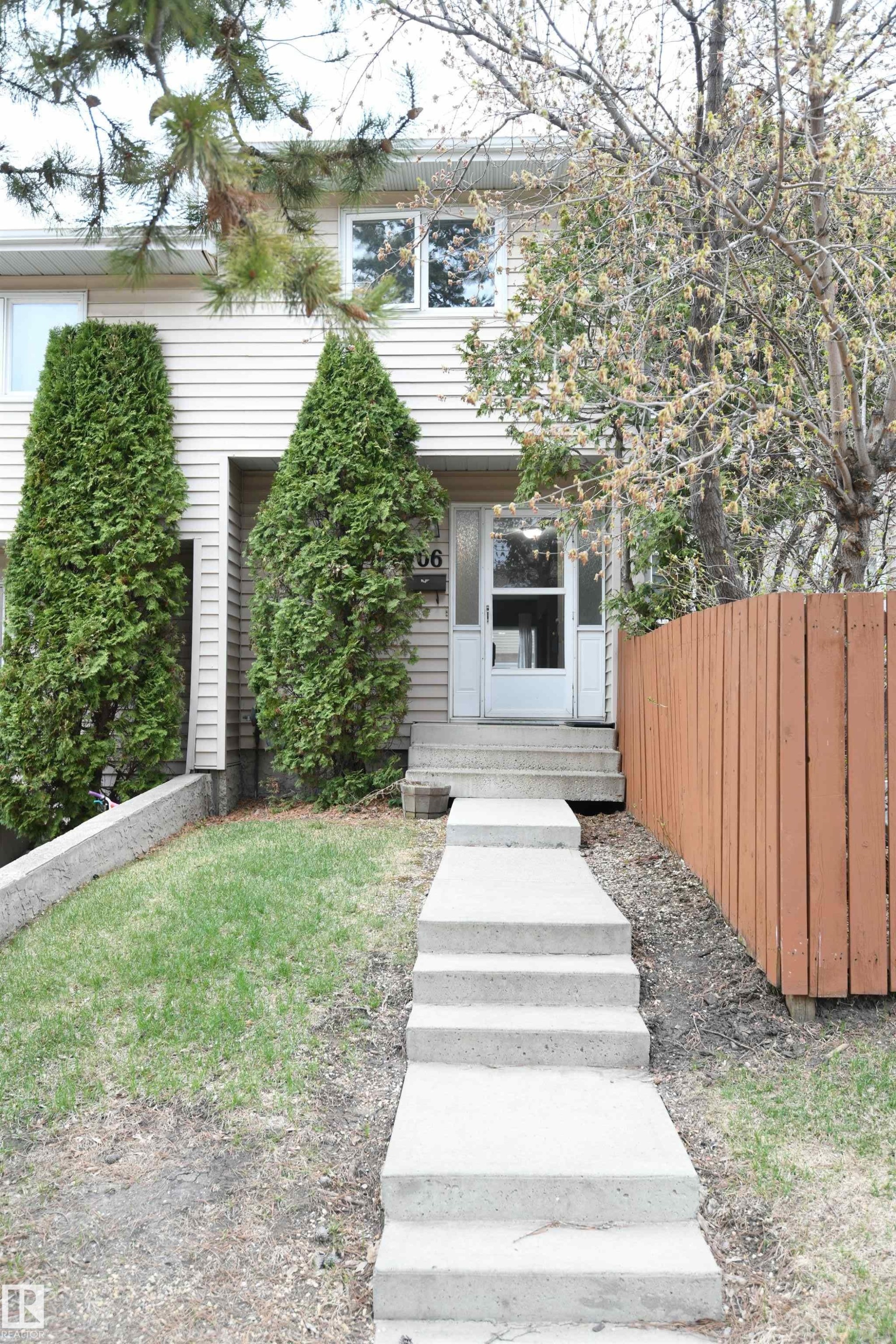 The private front entrance is nicely treed, and is only a few steps away from the assigned parking stall for the unit. Additional street parking is conveniently also located just beyond that - 6706 36A Avenue, Edmonton, AB - Outdoor