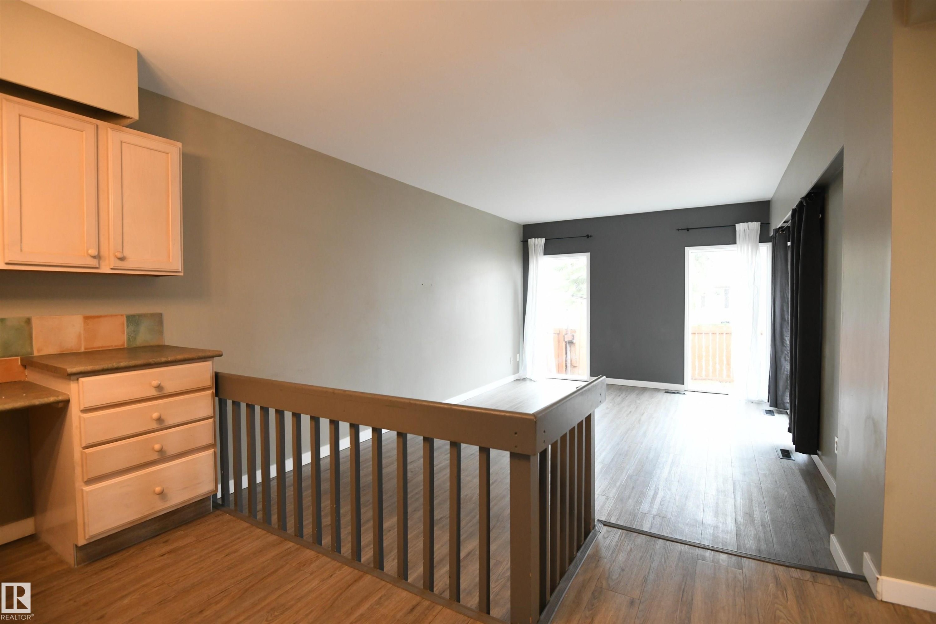Floor to ceiling windows at the far end of the living room let in great natural light, and are a nice touch. Patio doors lead from the living room to the private rear deck and yard as well - 6706 36A Avenue, Edmonton, AB - Indoor Photo Showing Other Room