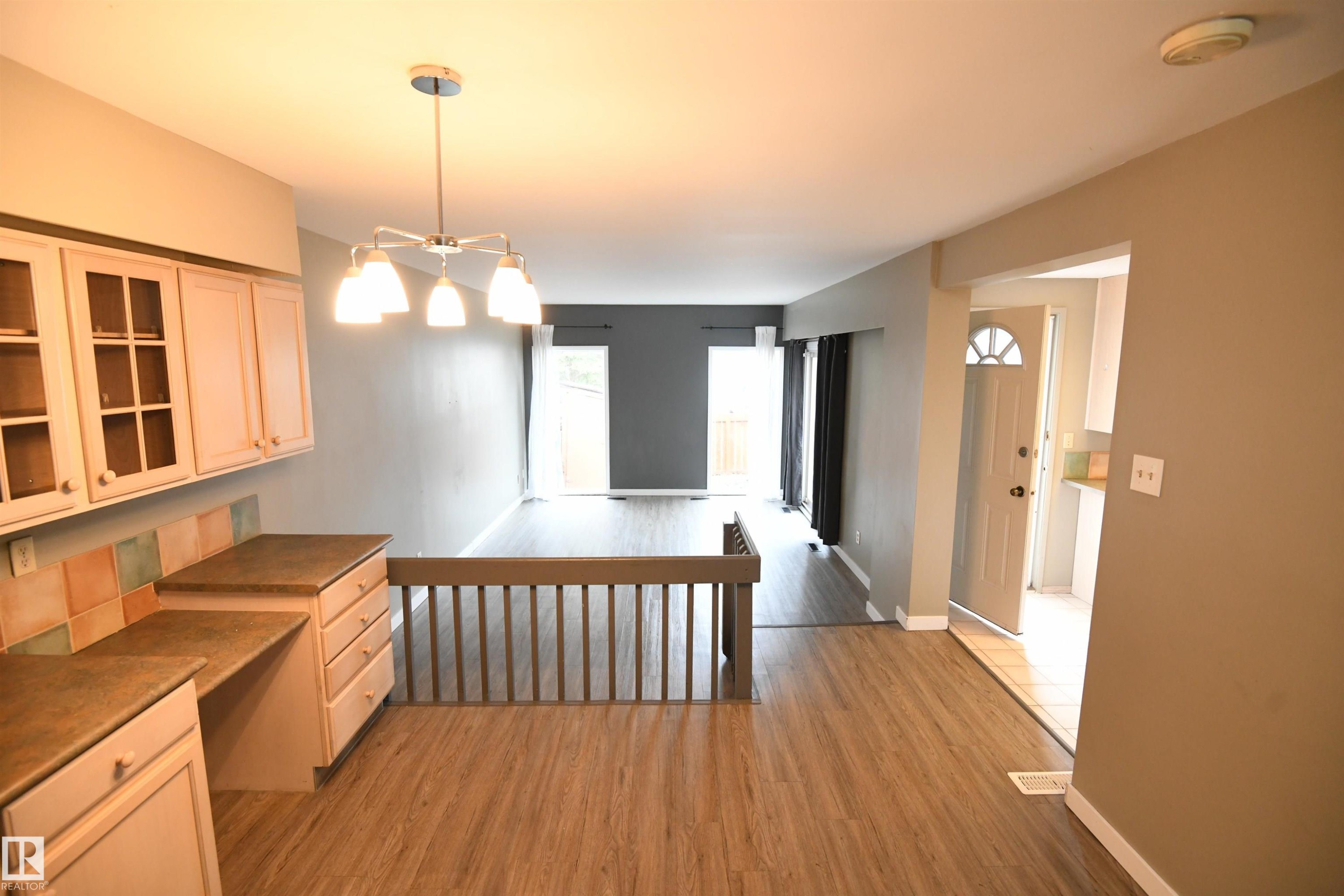 Floor to ceiling windows at the far end of the living room let in great natural light, and are a nice touch. Patio doors lead from the living room to the private rear deck and yard as well - 6706 36A Avenue, Edmonton, AB - Indoor