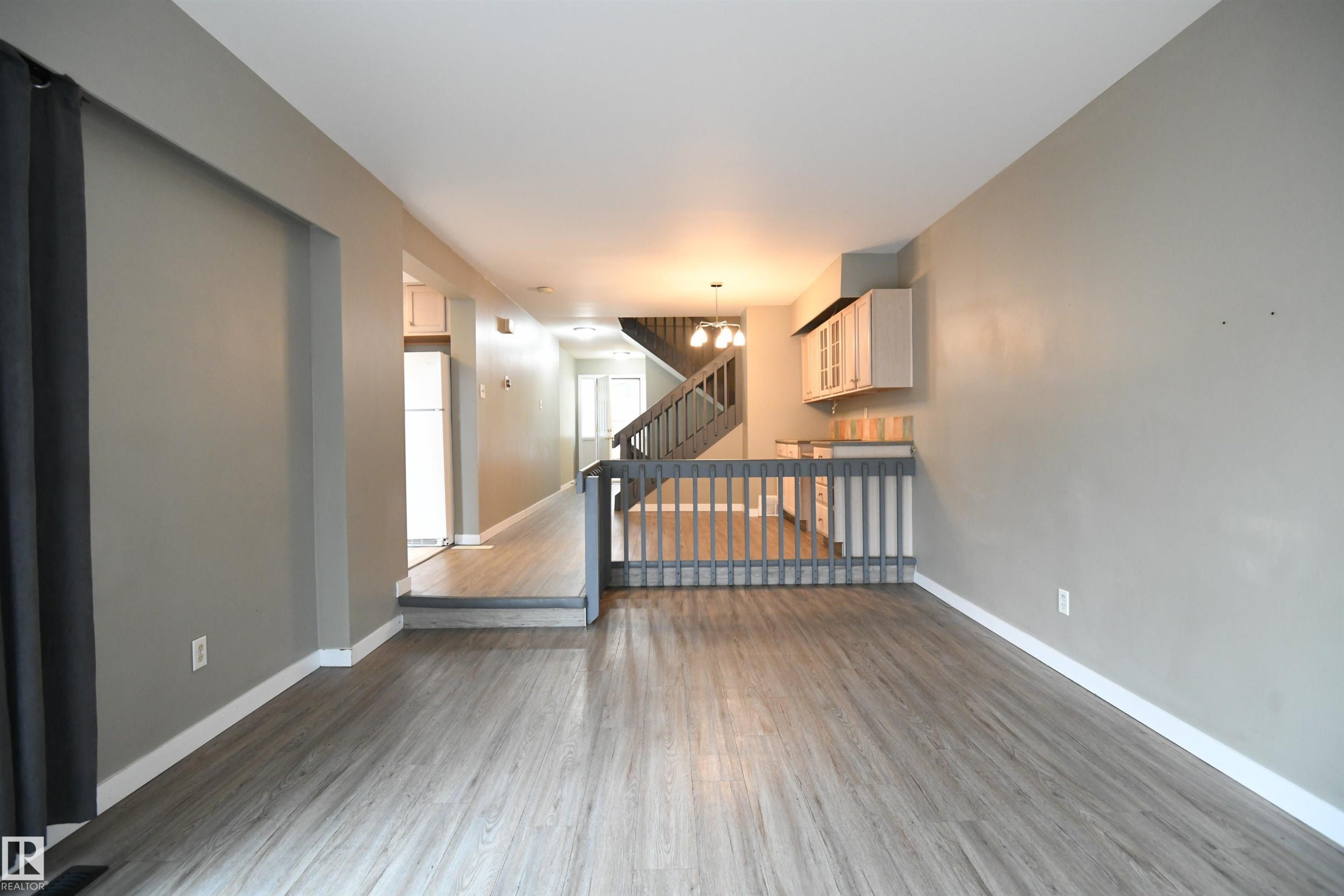 The open layout really does provide some great options for furniture placement, and makes for a great family and entertaining space. The patio doors open on to the private rear deck and yard - 6706 36A Avenue, Edmonton, AB - Indoor Photo Showing Other Room
