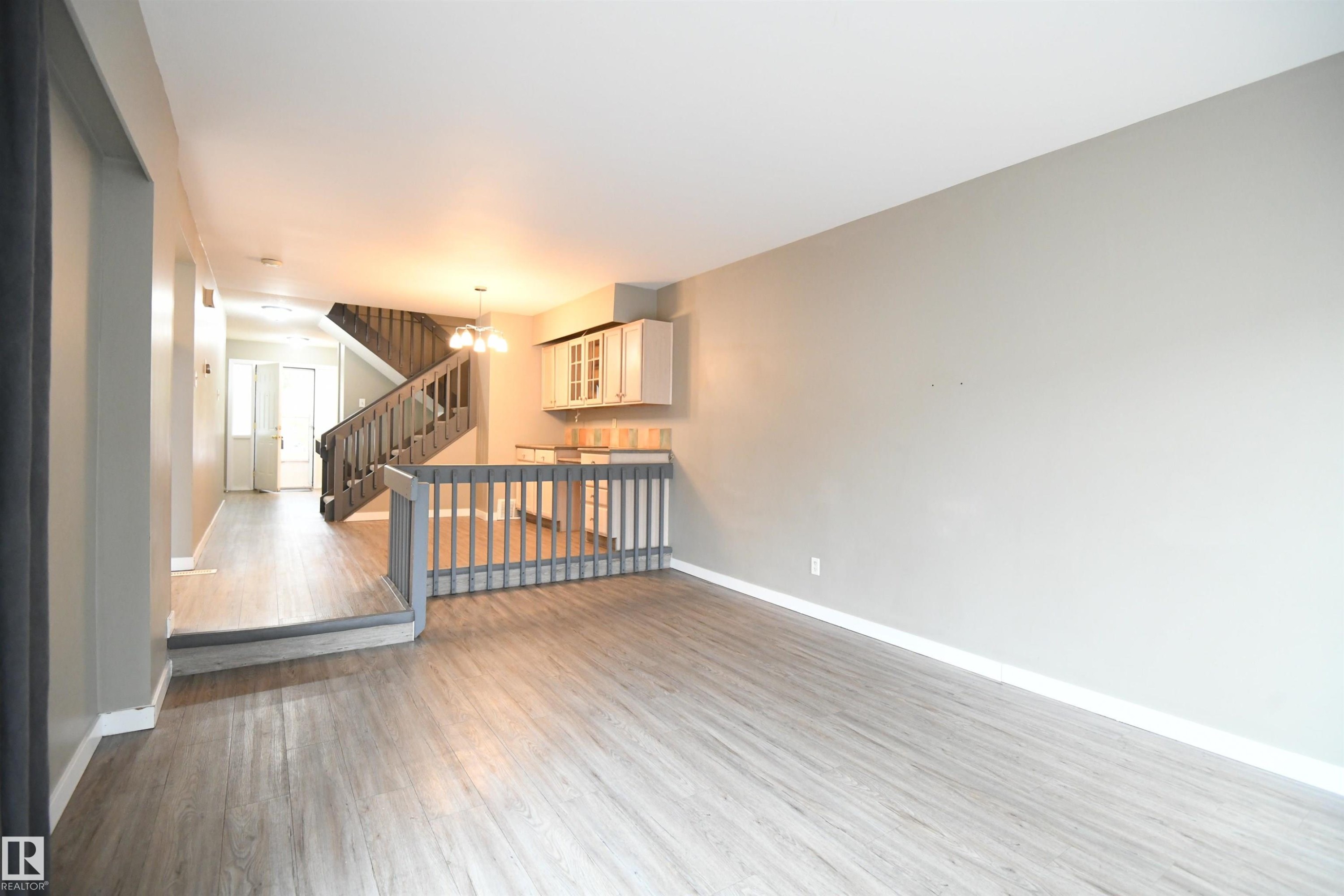 The open layout really does provide some great options for furniture placement, and makes for a great family and entertaining space. The patio doors open on to the private rear deck and yard - 6706 36A Avenue, Edmonton, AB - Indoor Photo Showing Other Room