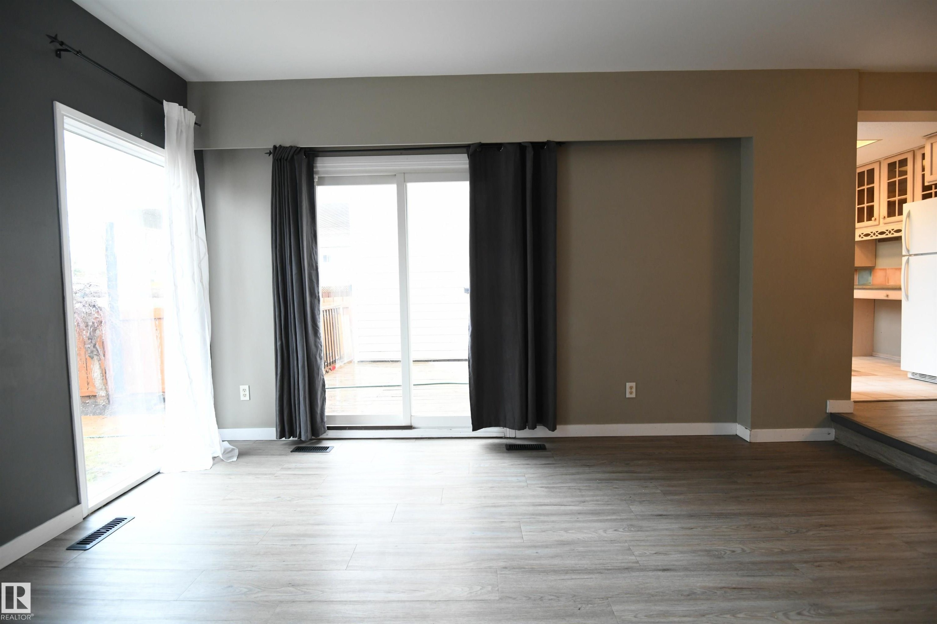 This unit has a private, walk up front entrance, as one may expect, but a paved rear lane outside the rear yard enhances access, puts more space between the neighbouring homes, & even allows for each unit to have their own trash collection. Convenience+ - 6706 36A Avenue, Edmonton, AB - Indoor Photo Showing Other Room