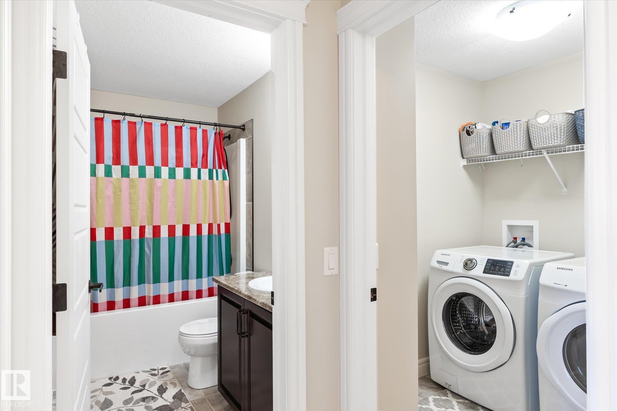 Dedicated laundry area with overhead shelving - 6864 Evans Wynd, Edmonton, AB - Indoor Photo Showing Laundry Room