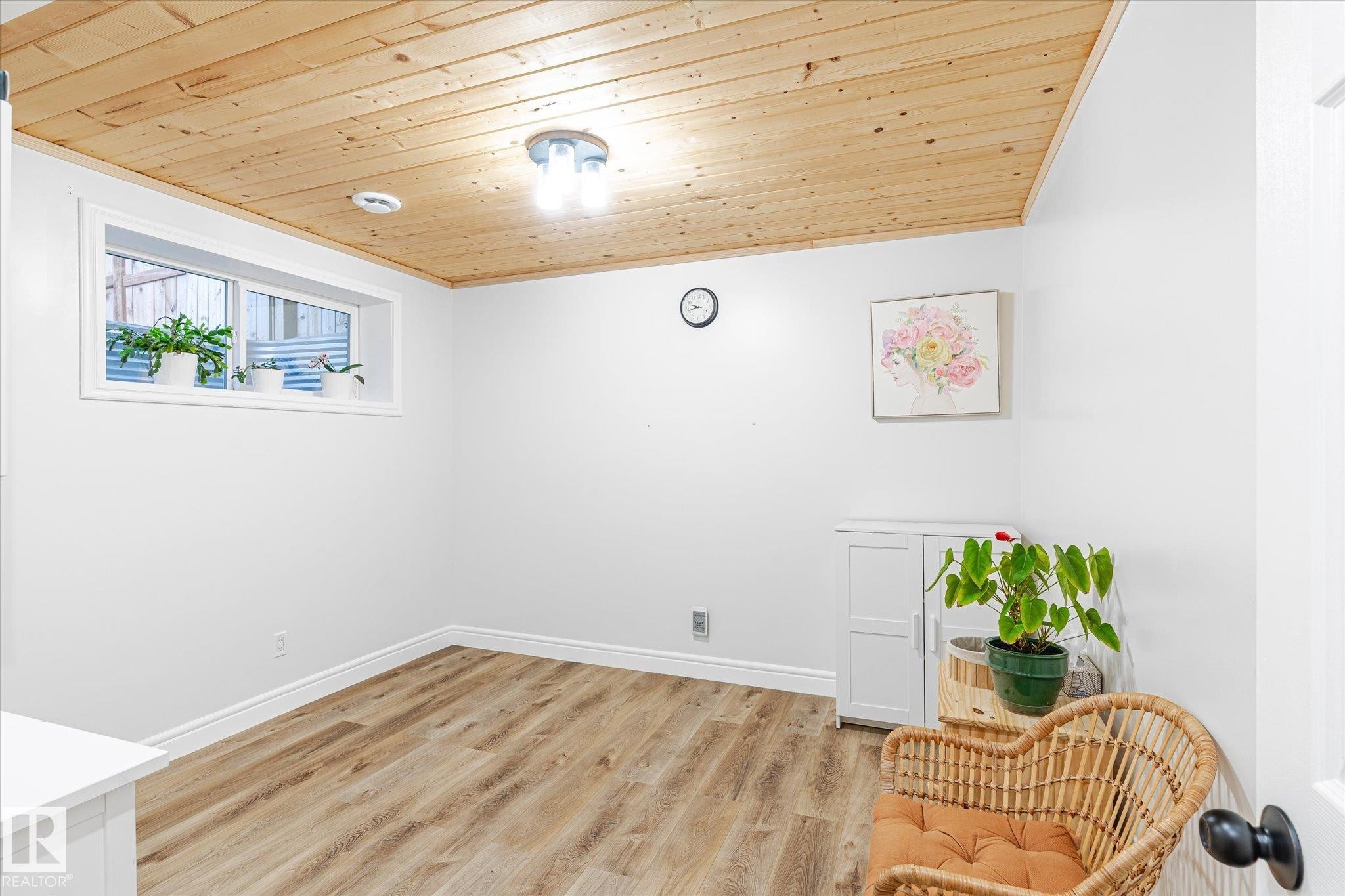 Room featuring wood-finish flooring and a natural wood plank ceiling - 6864 Evans Wynd, Edmonton, AB - Indoor Photo Showing Other Room