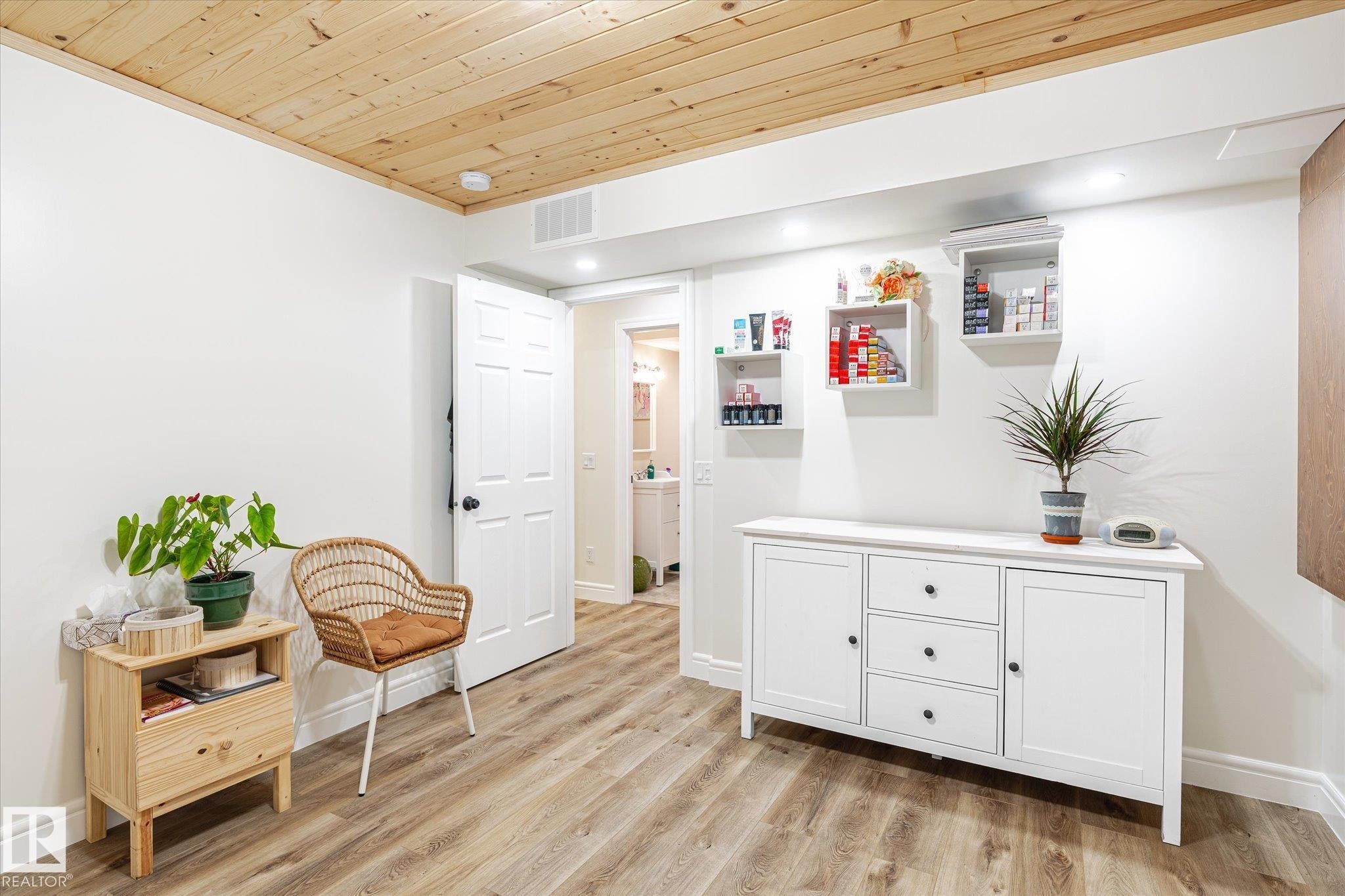 Wood-finish flooring with a natural wood plank ceiling - 6864 Evans Wynd, Edmonton, AB - Indoor Photo Showing Other Room
