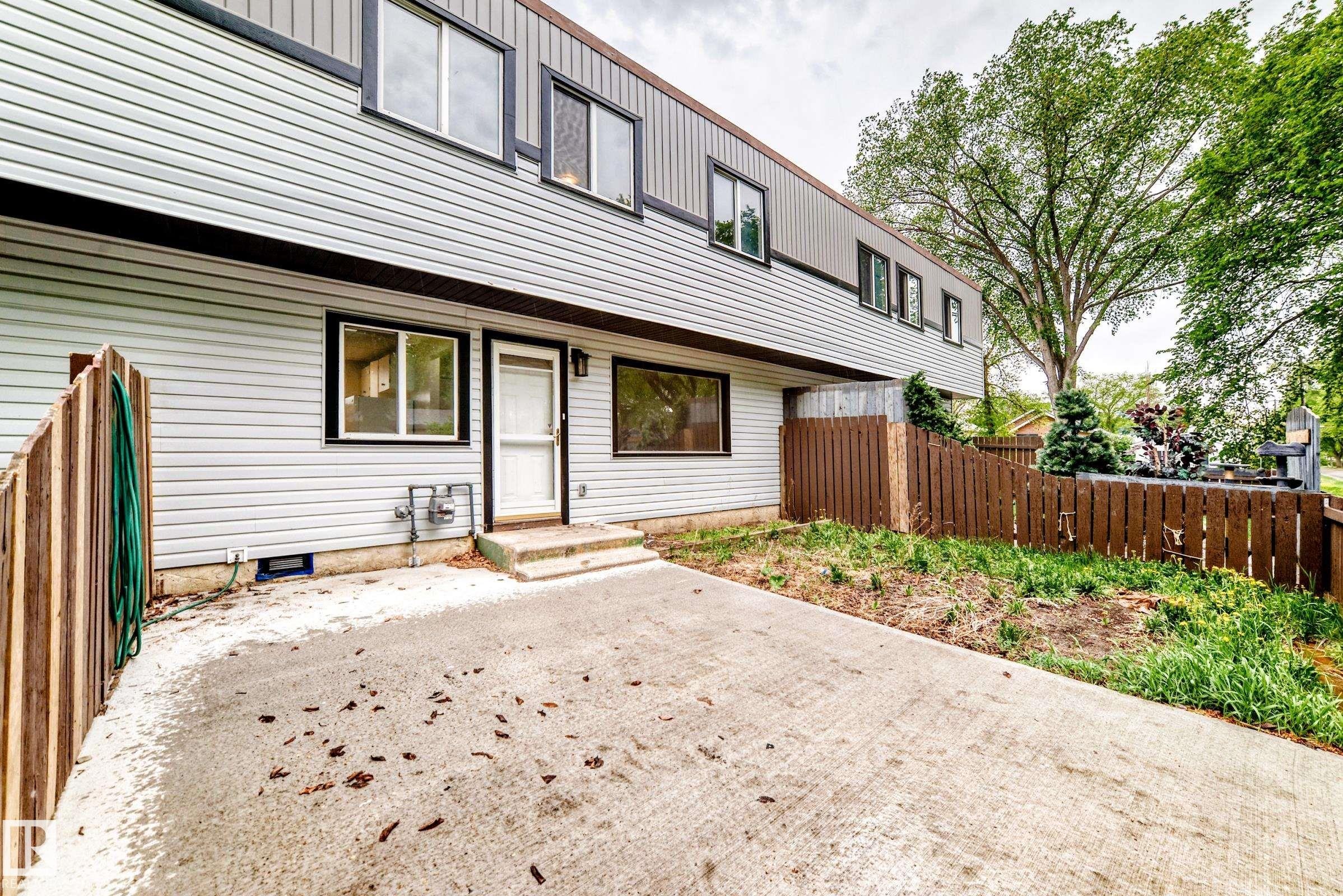 Multi-story exterior with light-toned horizontal siding and dark trim - 6117 120 Avenue, Edmonton, AB - Outdoor