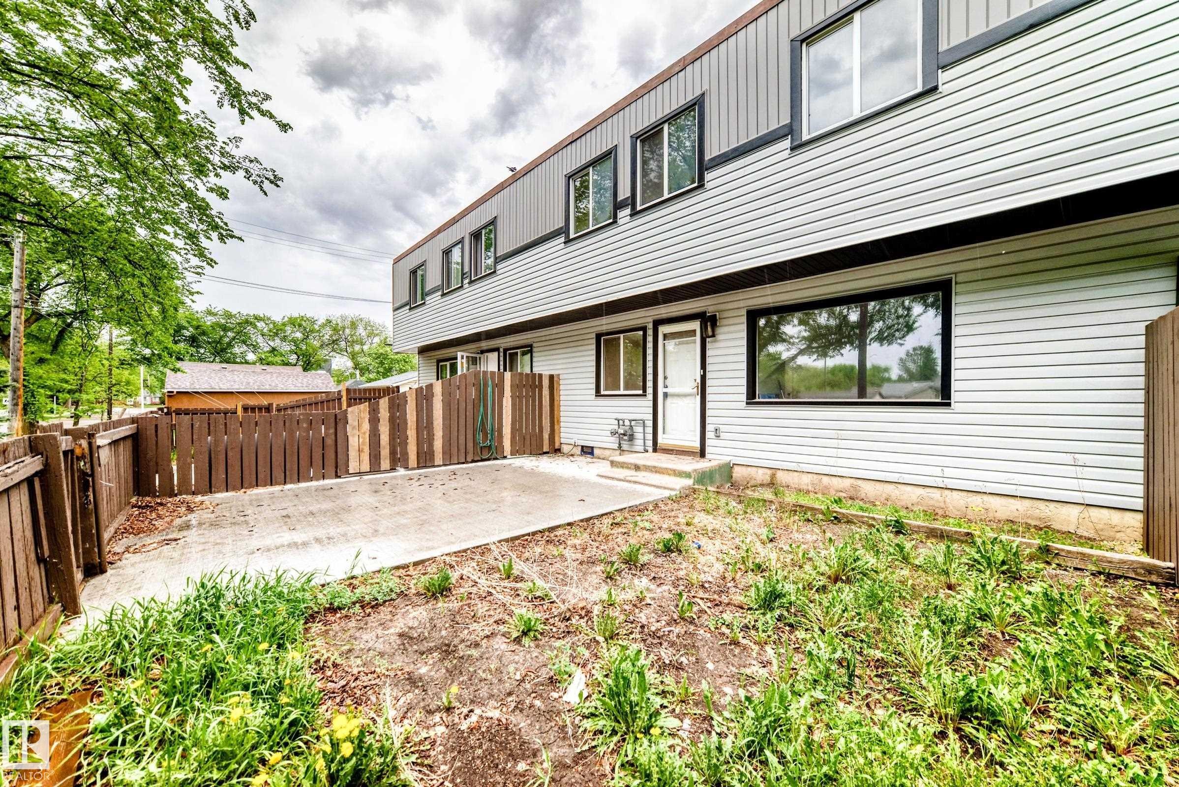 Multi-level exterior with light-colored siding and dark trim - 6117 120 Avenue, Edmonton, AB - Outdoor With Exterior