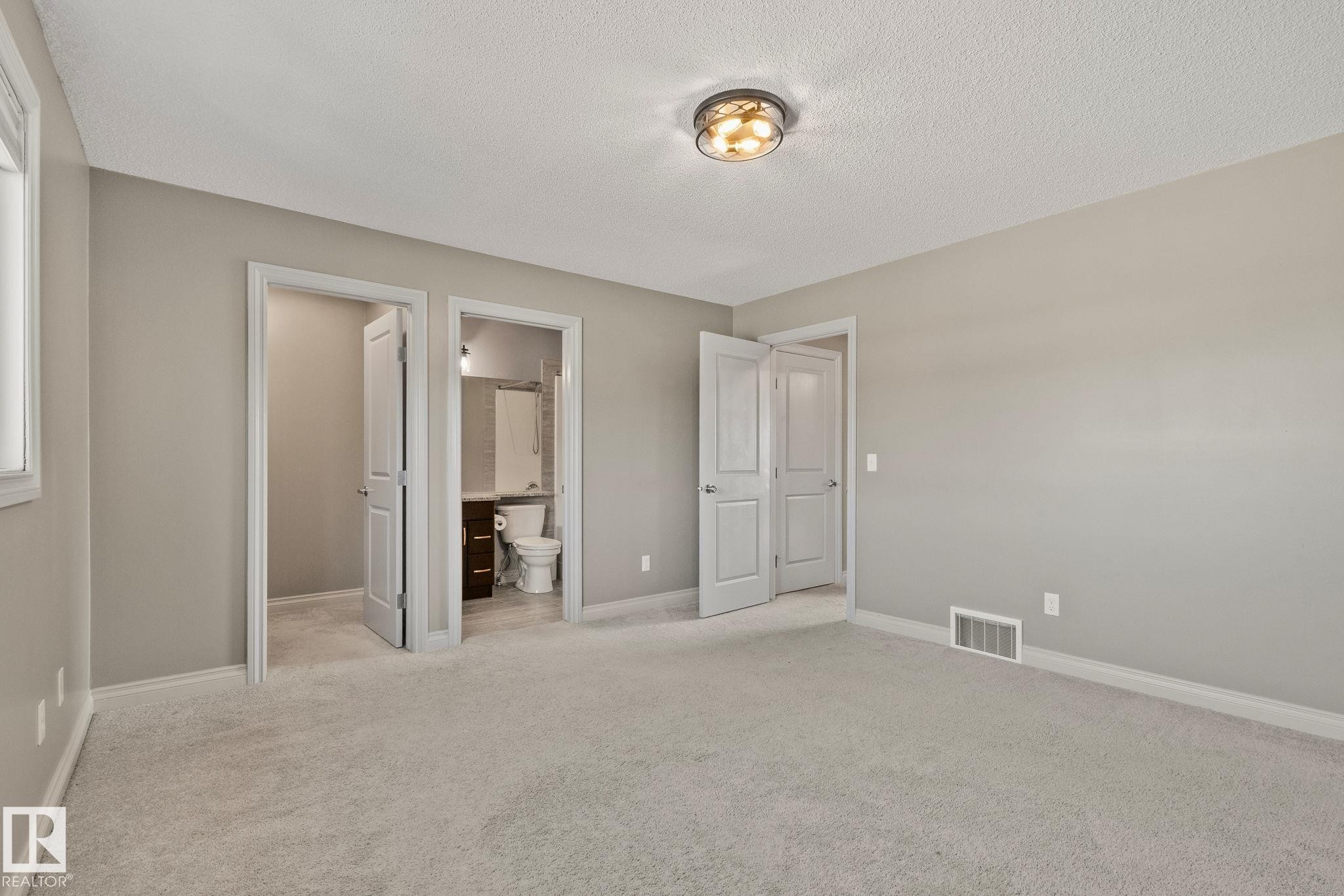 Carpeted room with neutral wall tones and a ceiling-mounted light fixture - 46 445 Brintnell Boulevard, Edmonton, AB - Indoor Photo Showing Other Room