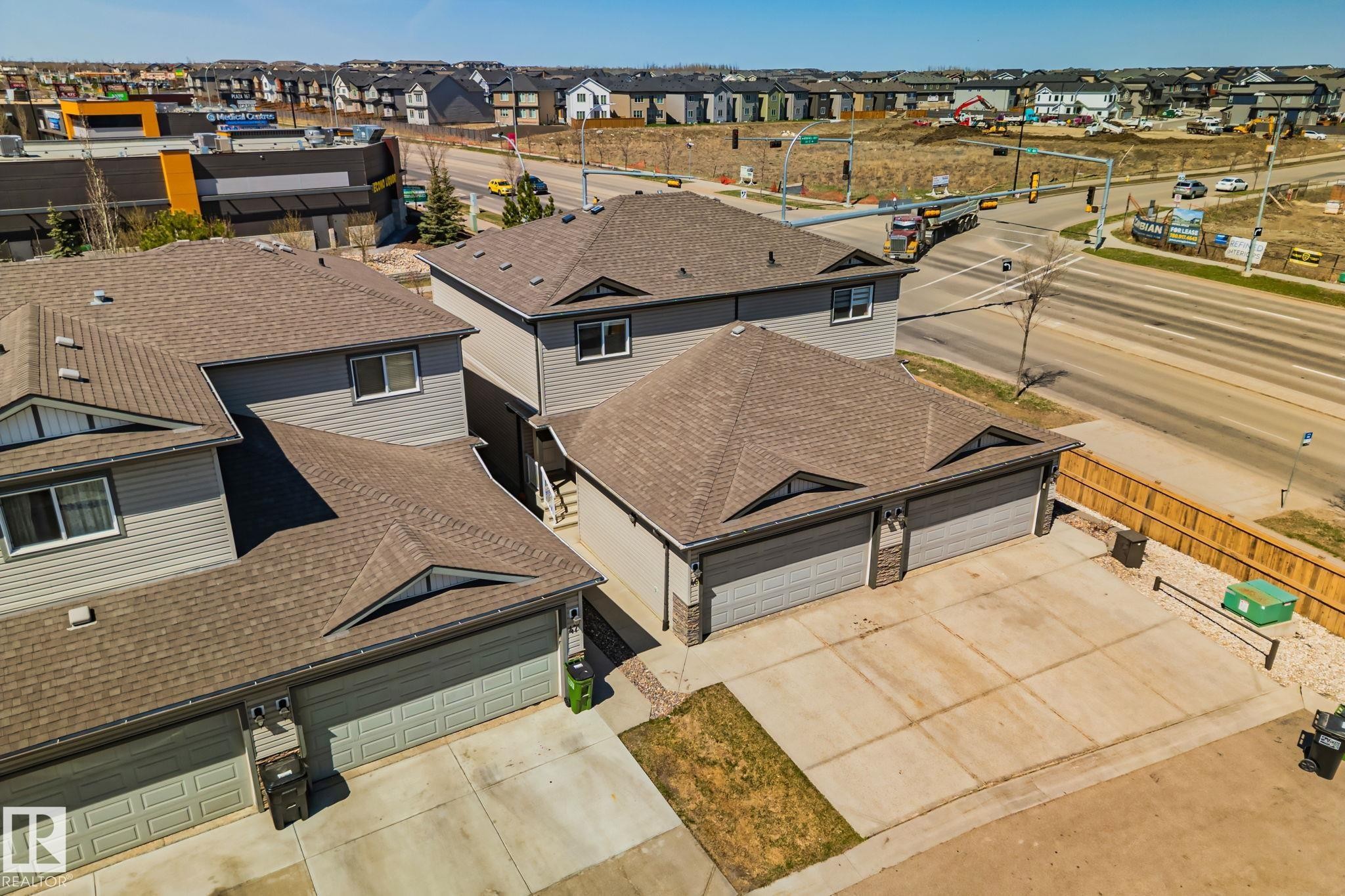 Contemporary residential structure featuring gray siding and a brown shingle roof - 46 445 Brintnell Boulevard, Edmonton, AB - Outdoor