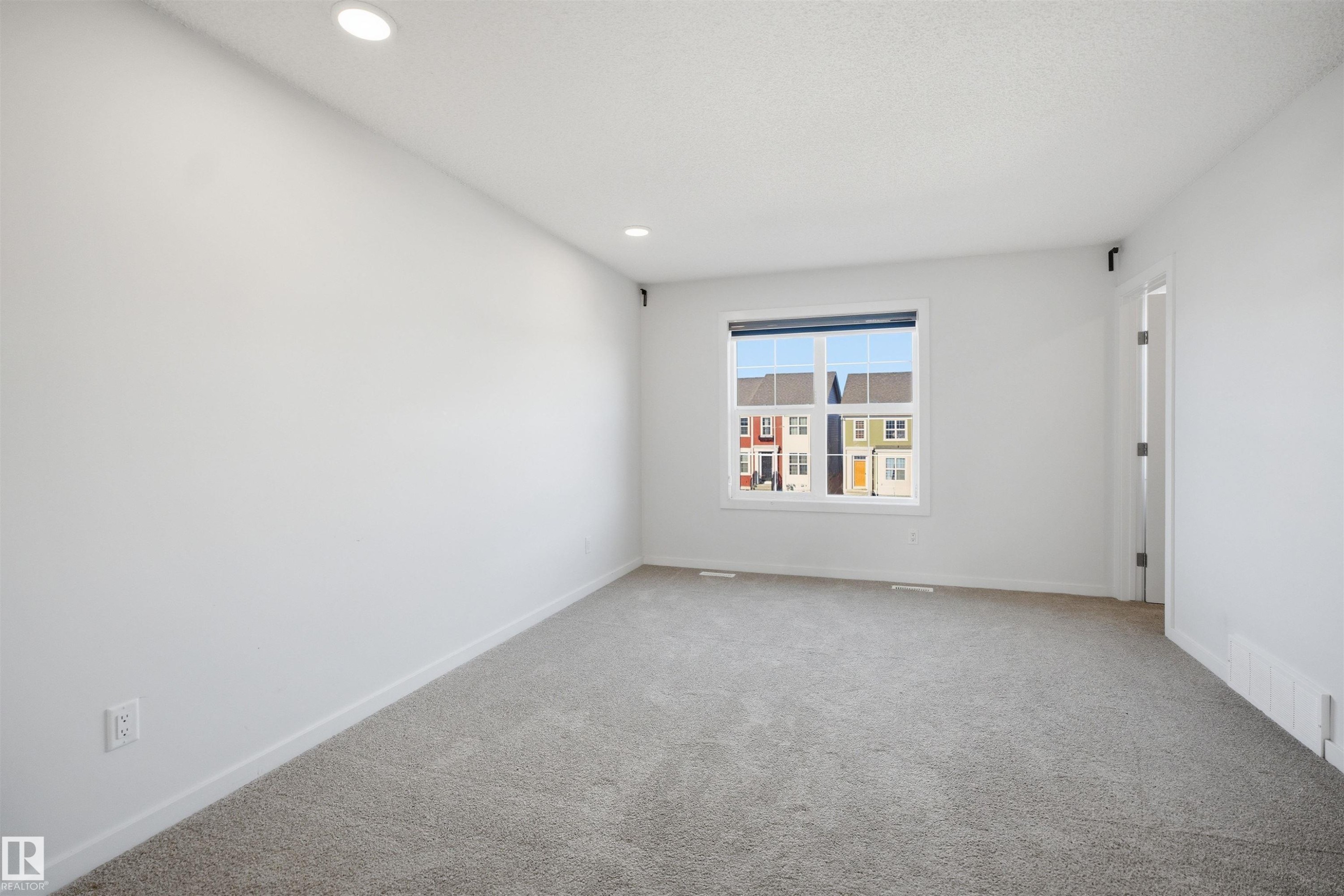 Room featuring neutral tone carpet, white walls, and recessed lighting - 2125 Maple Road Nw, Edmonton, AB - Indoor Photo Showing Other Room