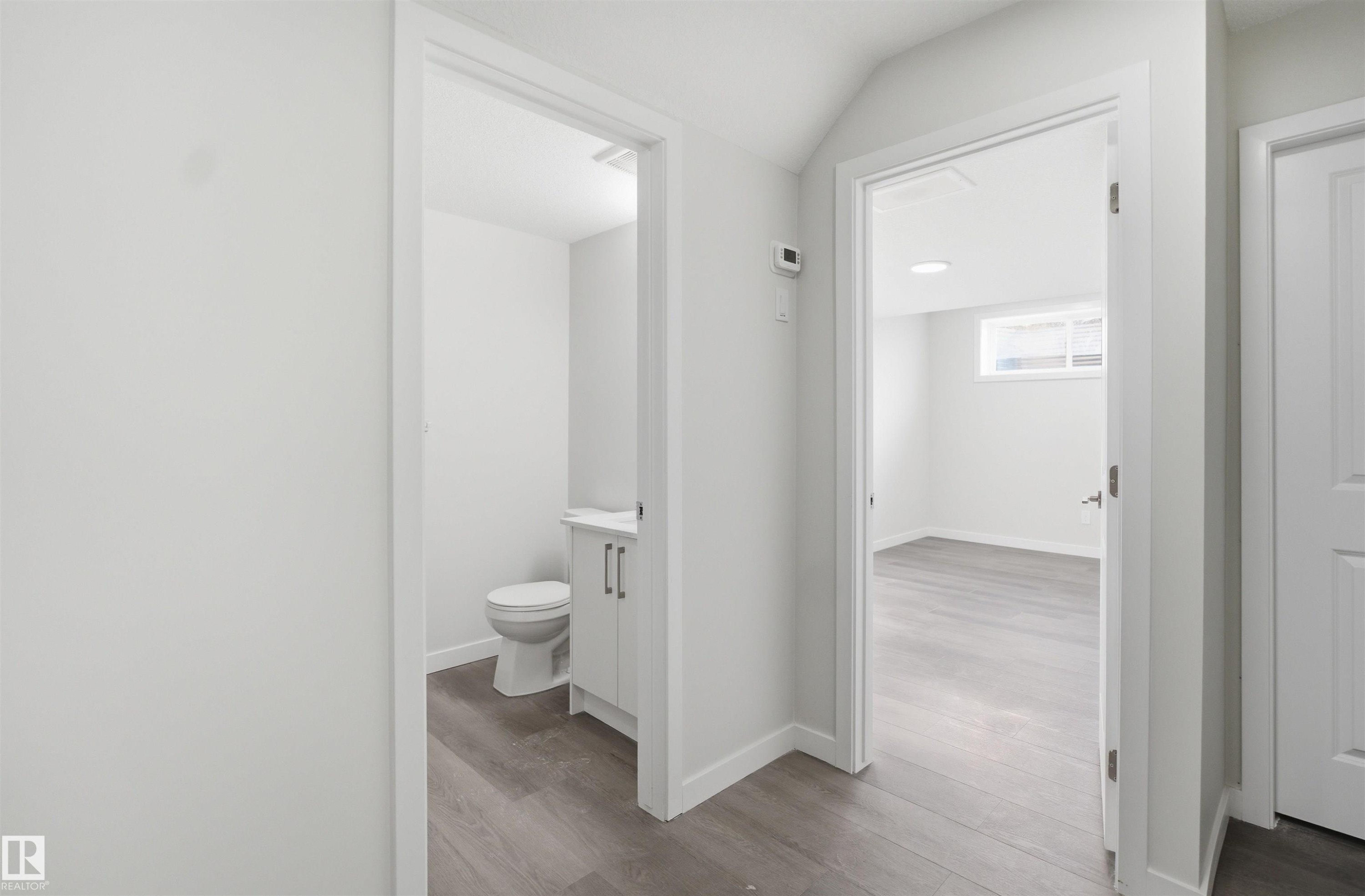Interior view featuring wood-style flooring and white painted walls - 2125 Maple Road Nw, Edmonton, AB - Indoor