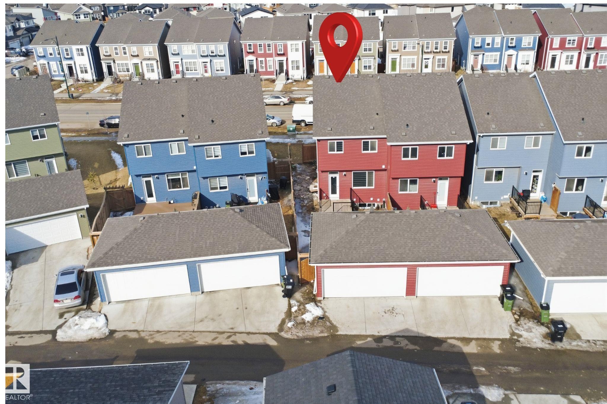 This property features a two-story design with a red exterior and a dark grey roof - 2125 Maple Road Nw, Edmonton, AB - Other