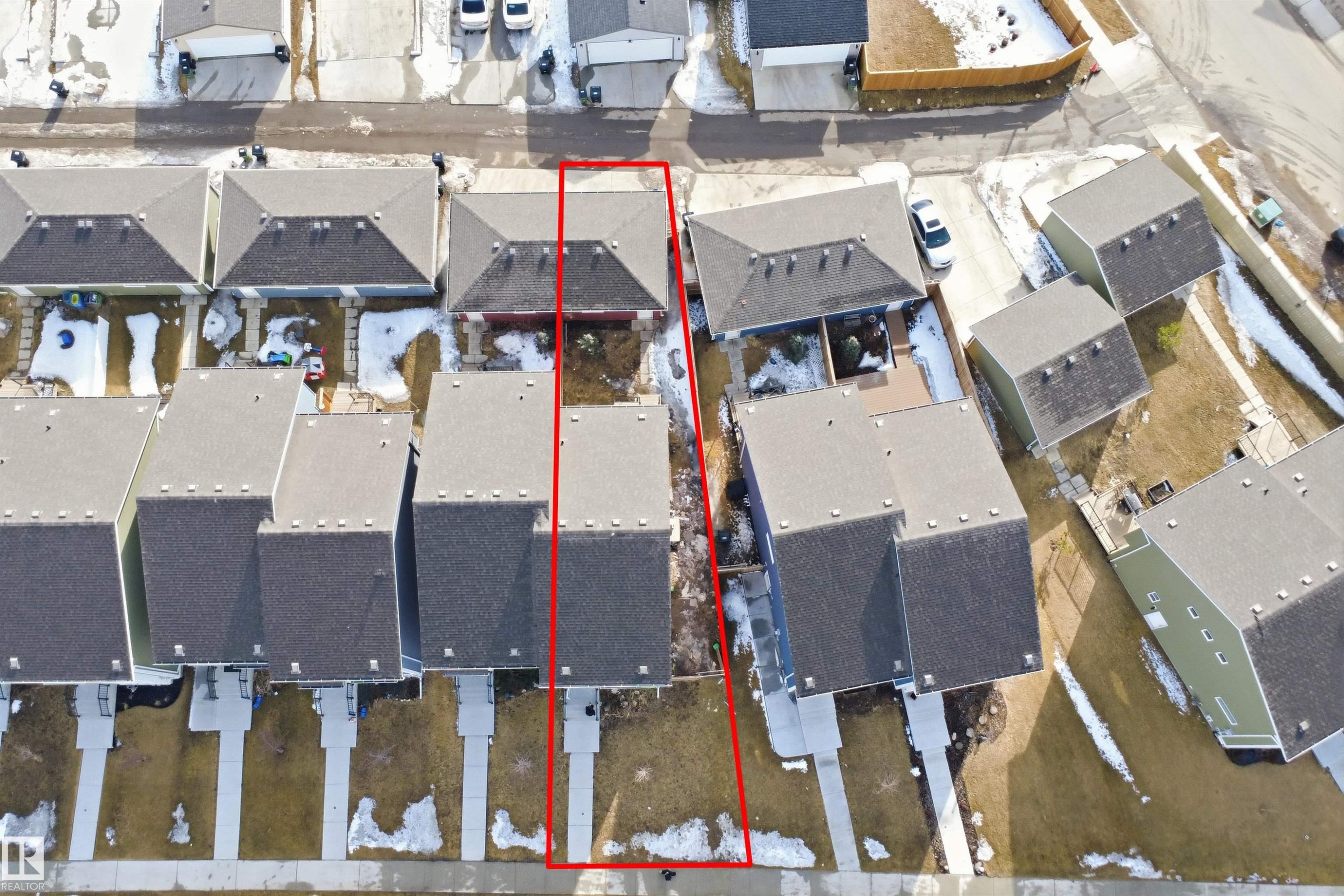 The property, outlined in red, features a dark-colored roof and a private yard space - 2125 Maple Road Nw, Edmonton, AB -