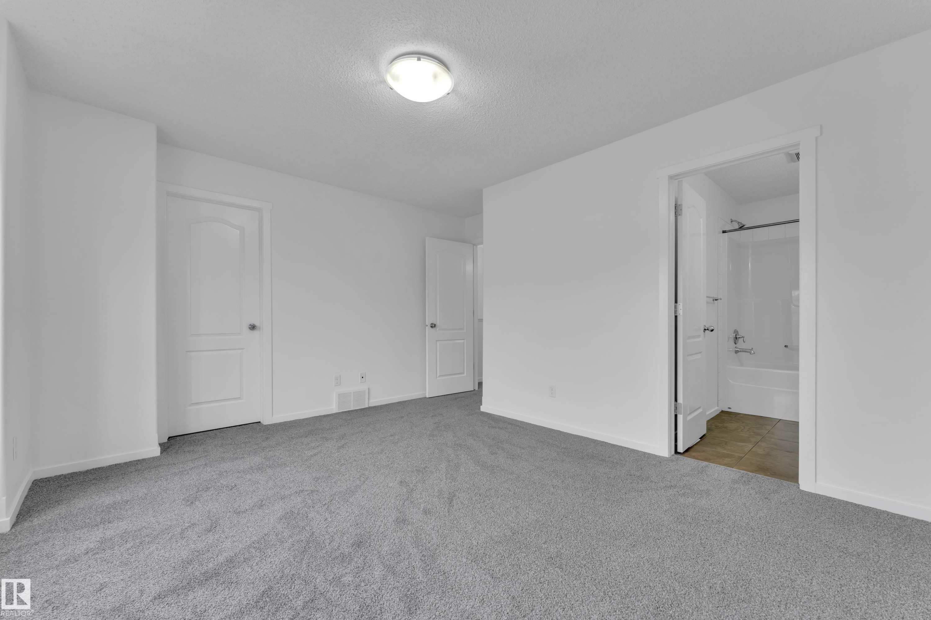Neutral paint colors complement the grey carpeting throughout this space - 2143 32 Street, Edmonton, AB