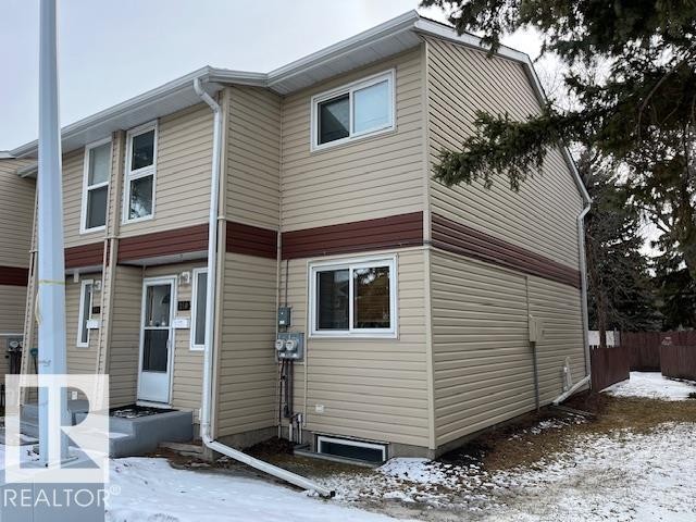 The property features a two-story exterior with light-colored siding and contrasting darker trim - 350 Clareview Road, Edmonton, AB - Outdoor