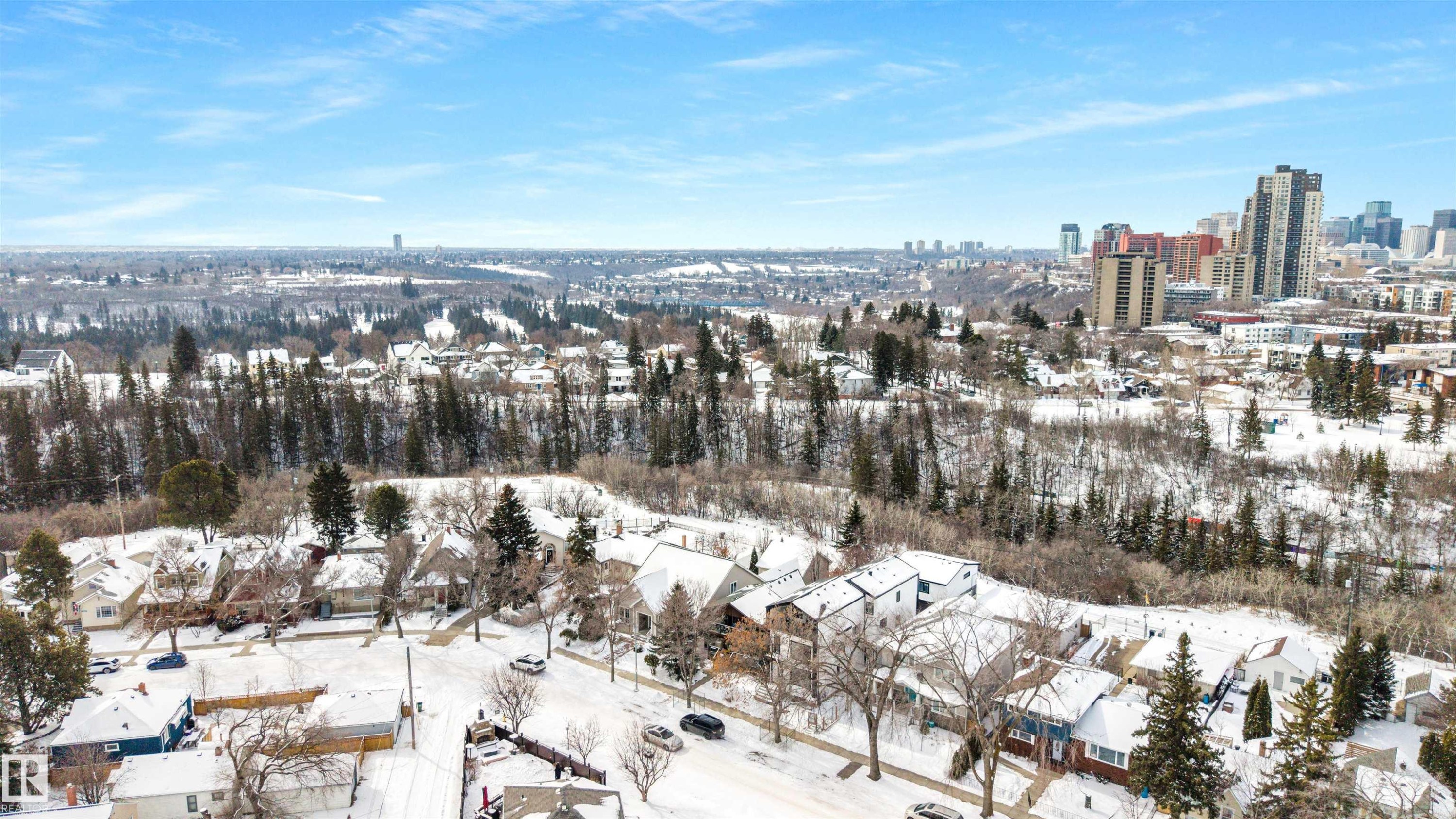 The property is located in a neighborhood featuring residential streets with snow-covered homes and trees - 7927 112S Avenue, Edmonton, AB - Outdoor With View