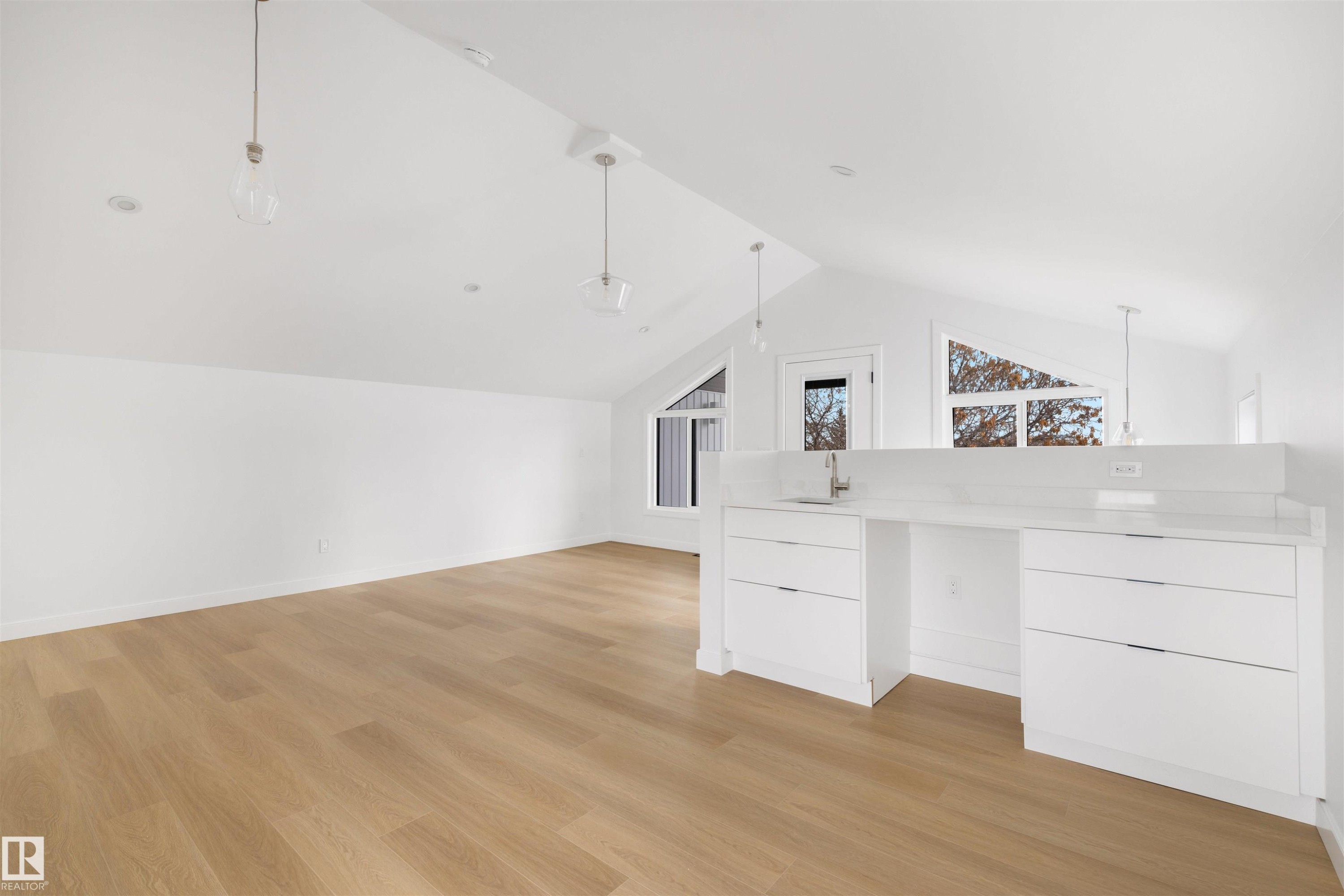 Spacious room with light wood flooring and crisp white walls - 7927 112S Avenue, Edmonton, AB - Indoor Photo Showing Other Room