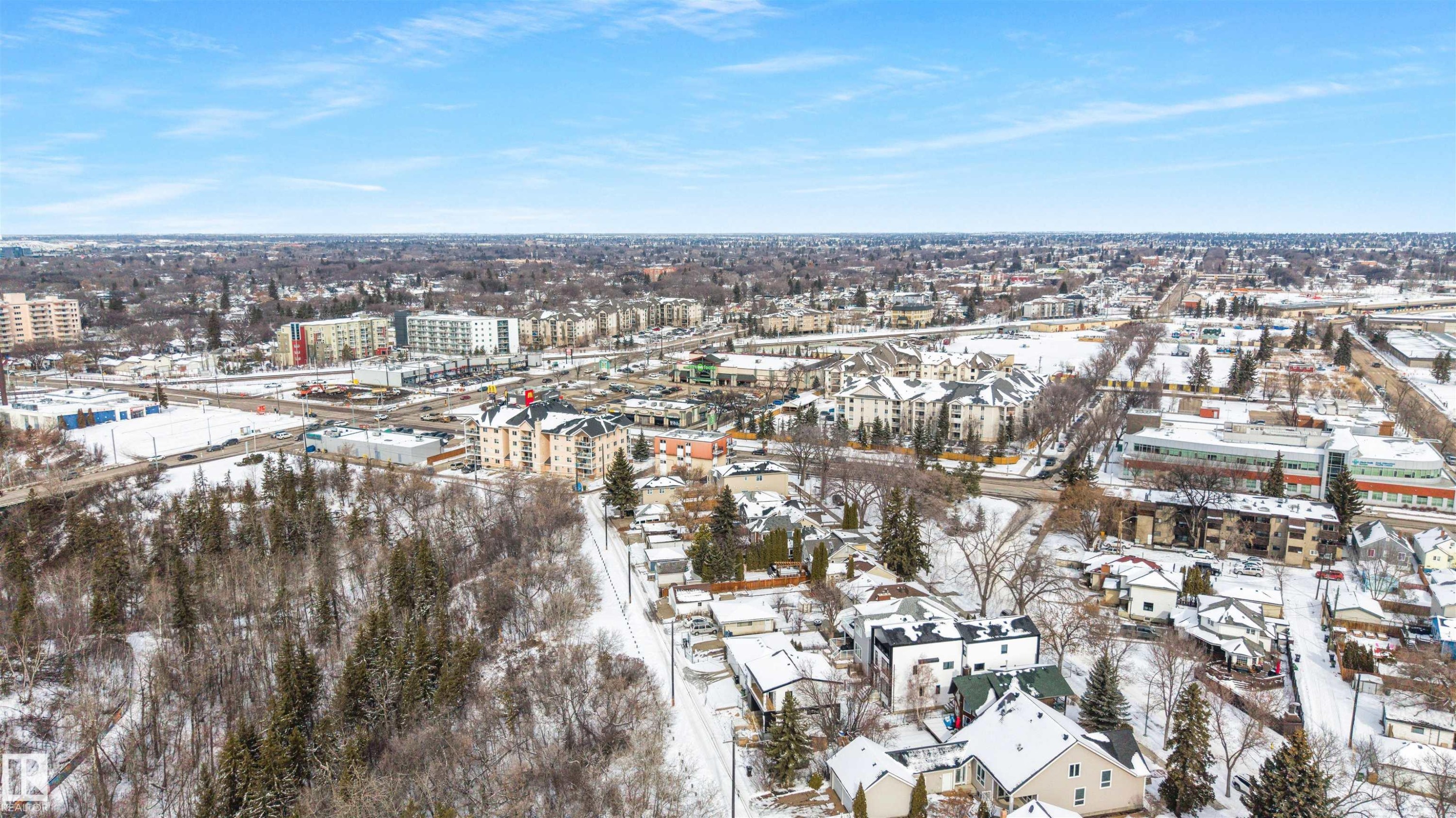 Aerial view showcasing the surrounding neighborhood with various buildings and snow-covered terrain - 7927 112S Avenue, Edmonton, AB - Outdoor With View