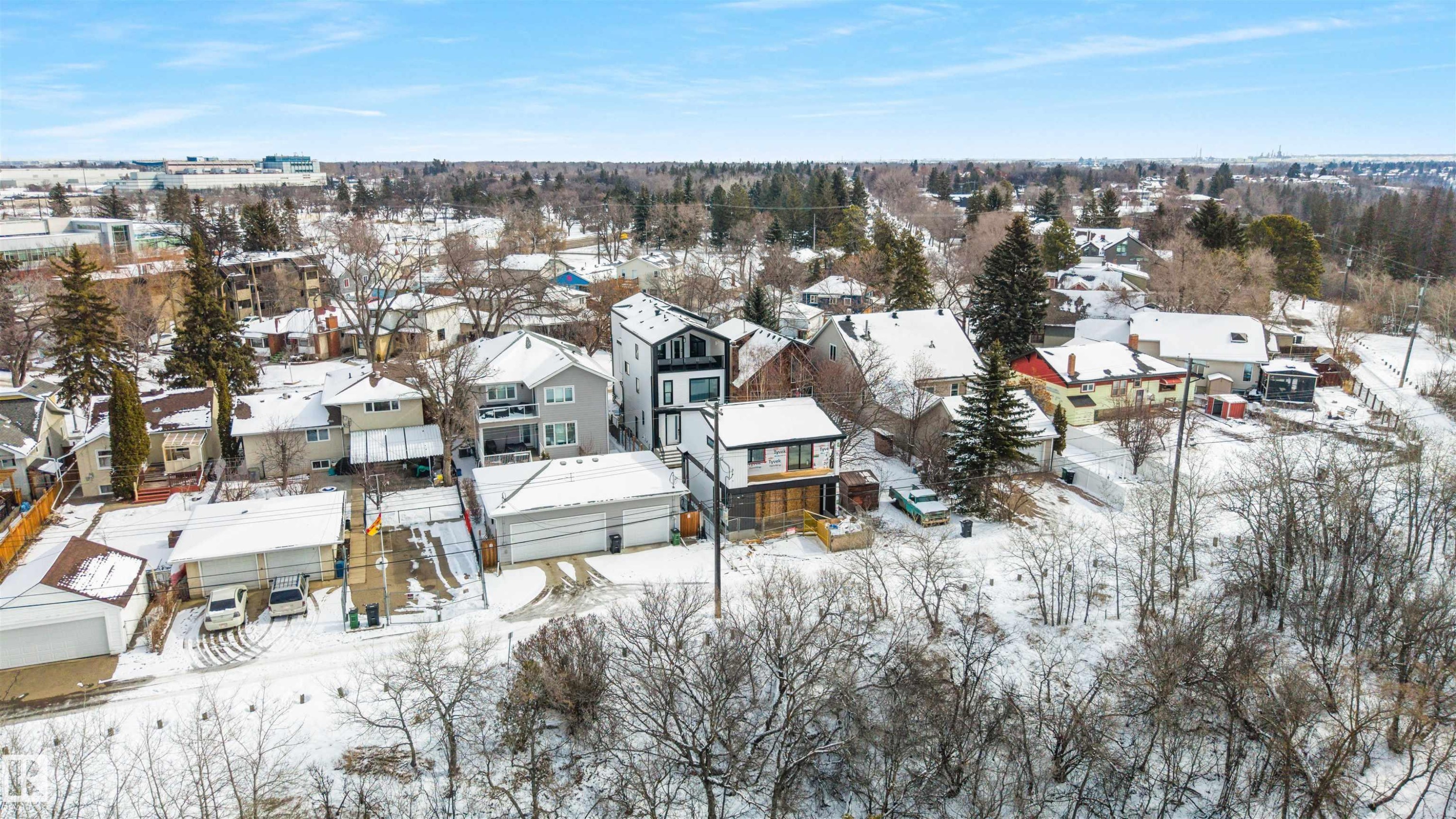 This aerial view showcases the property within a residential setting, featuring various housing styles and an abundance of mature trees - 7927 112S Avenue, Edmonton, AB - Outdoor With View