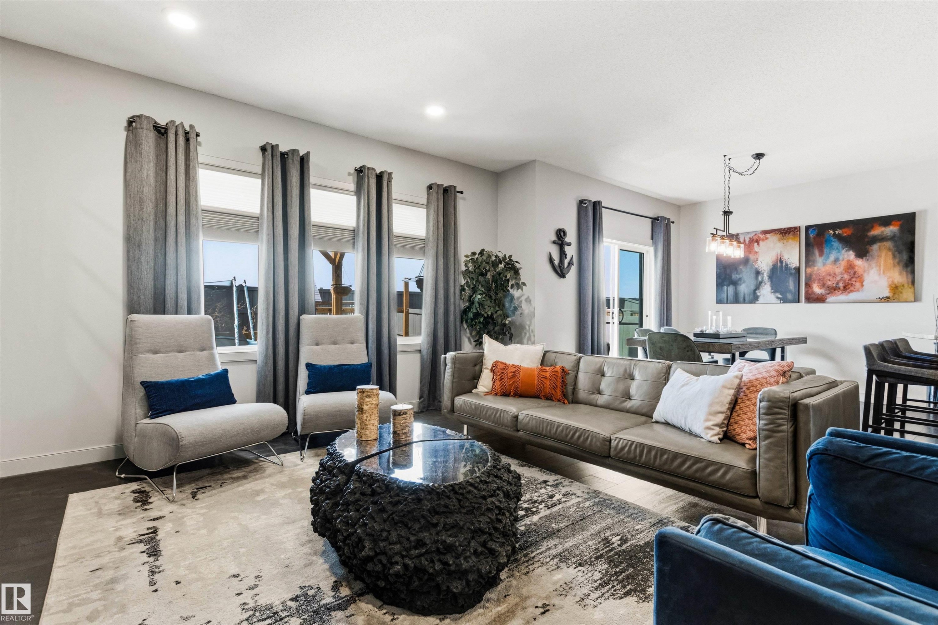 Open-concept living area featuring dark wood-finish flooring and recessed lighting - 7343 Armour Crescent, Edmonton, AB - Indoor Photo Showing Living Room