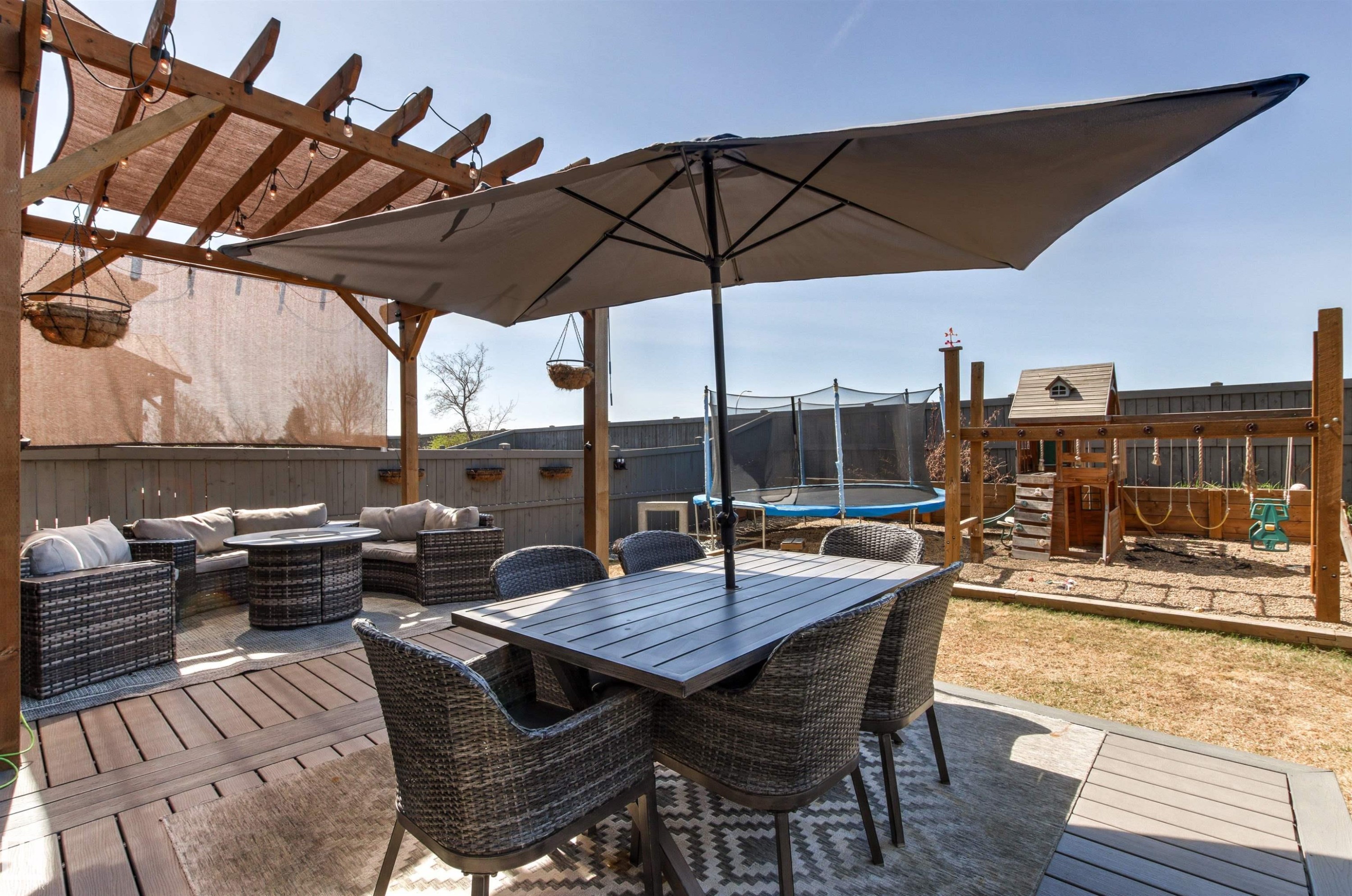 Expansive outdoor living area featuring a wood pergola with shade covering, a spacious deck, and a dining area with gas hook-up for bbq. - 7343 Armour Crescent, Edmonton, AB - Outdoor With Deck Patio Veranda With Exterior