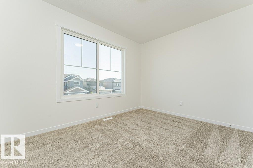 Bright room featuring light-toned walls and plush carpeting - 6271 180 Avenue Nw, Edmonton, AB
