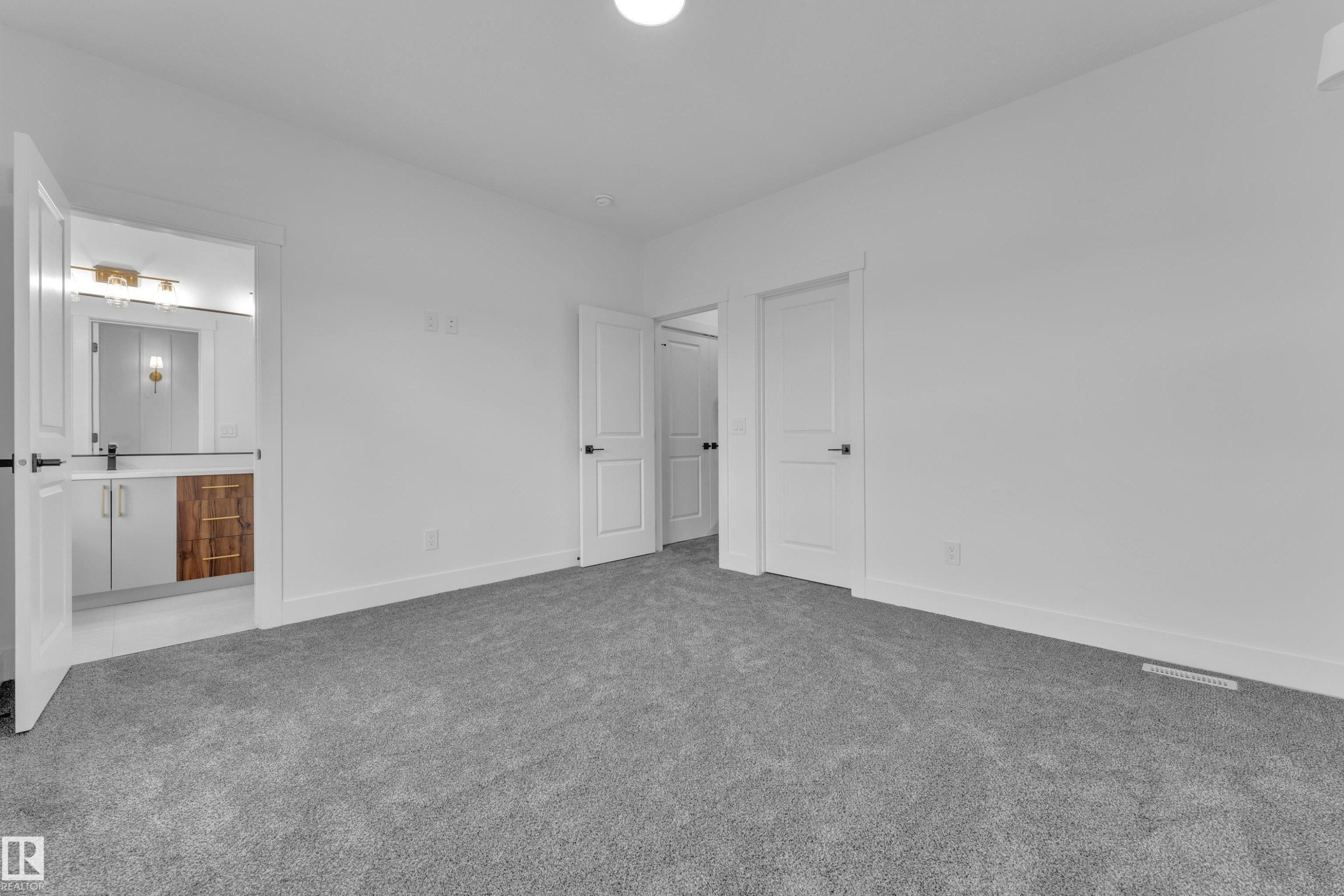 Interior room featuring neutral gray carpeting and white walls - 3116 8 Avenue, Edmonton, AB