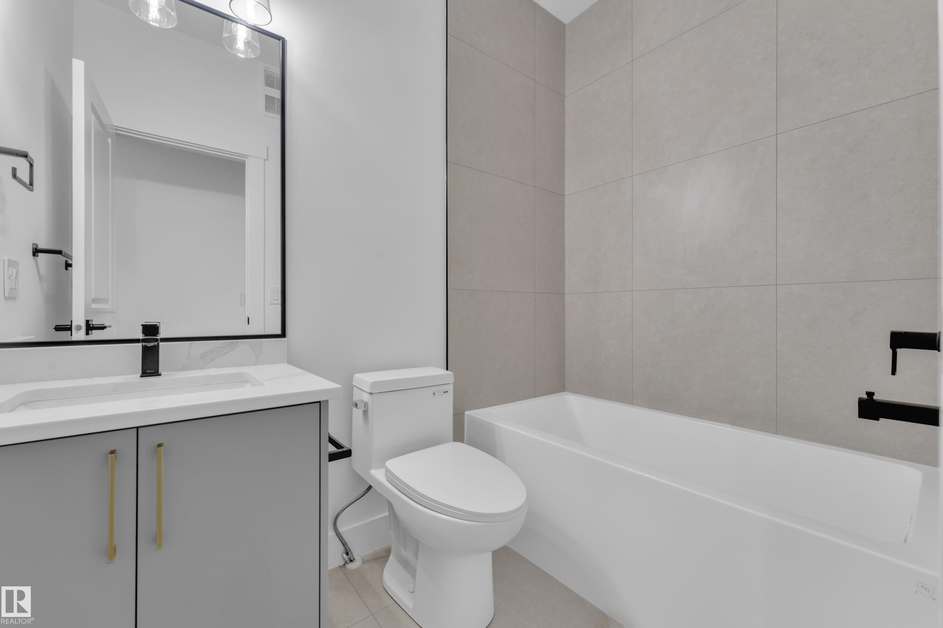 Bathroom featuring a modern vanity with a white countertop and rectangular sink - 3116 8 Avenue, Edmonton, AB