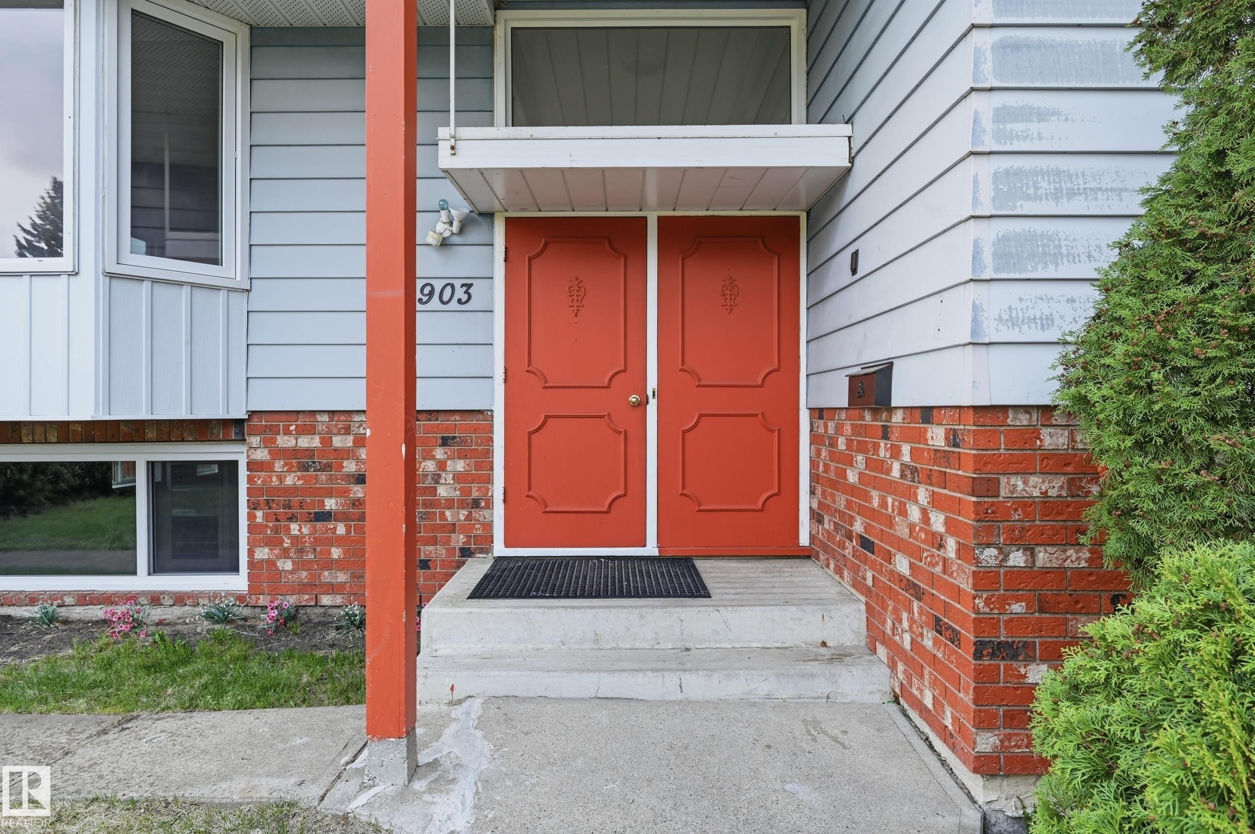 Inviting red double entry doors with decorative panels - 13903 87 Street, Edmonton, AB - Outdoor With Exterior