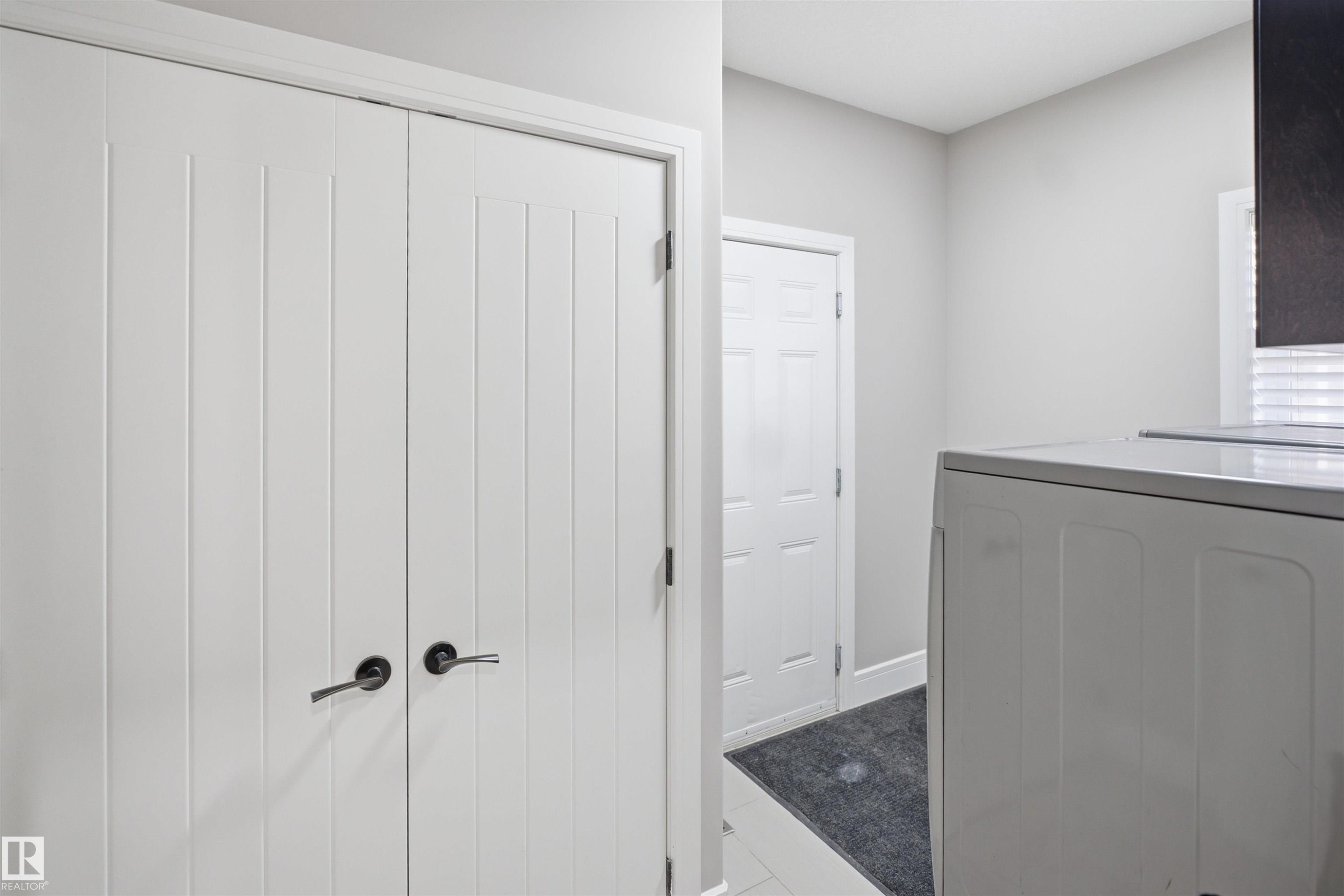 White paneled bifold doors with black hardware - 2256 Cameron Ravine Court, Edmonton, AB - Indoor