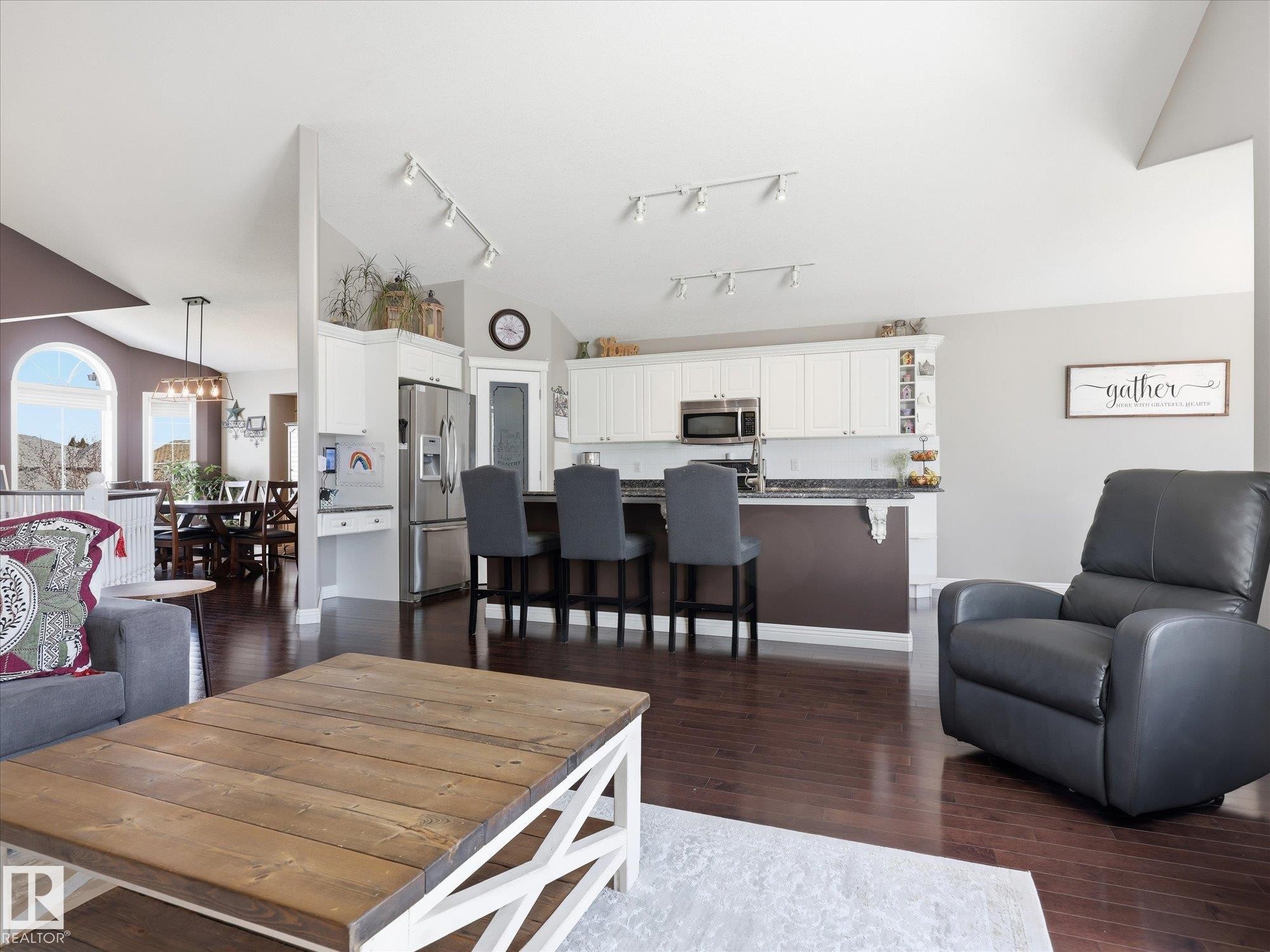 Open-concept living space featuring rich wood-finish flooring - 1340 Oakland Crescent, Devon, AB - Indoor