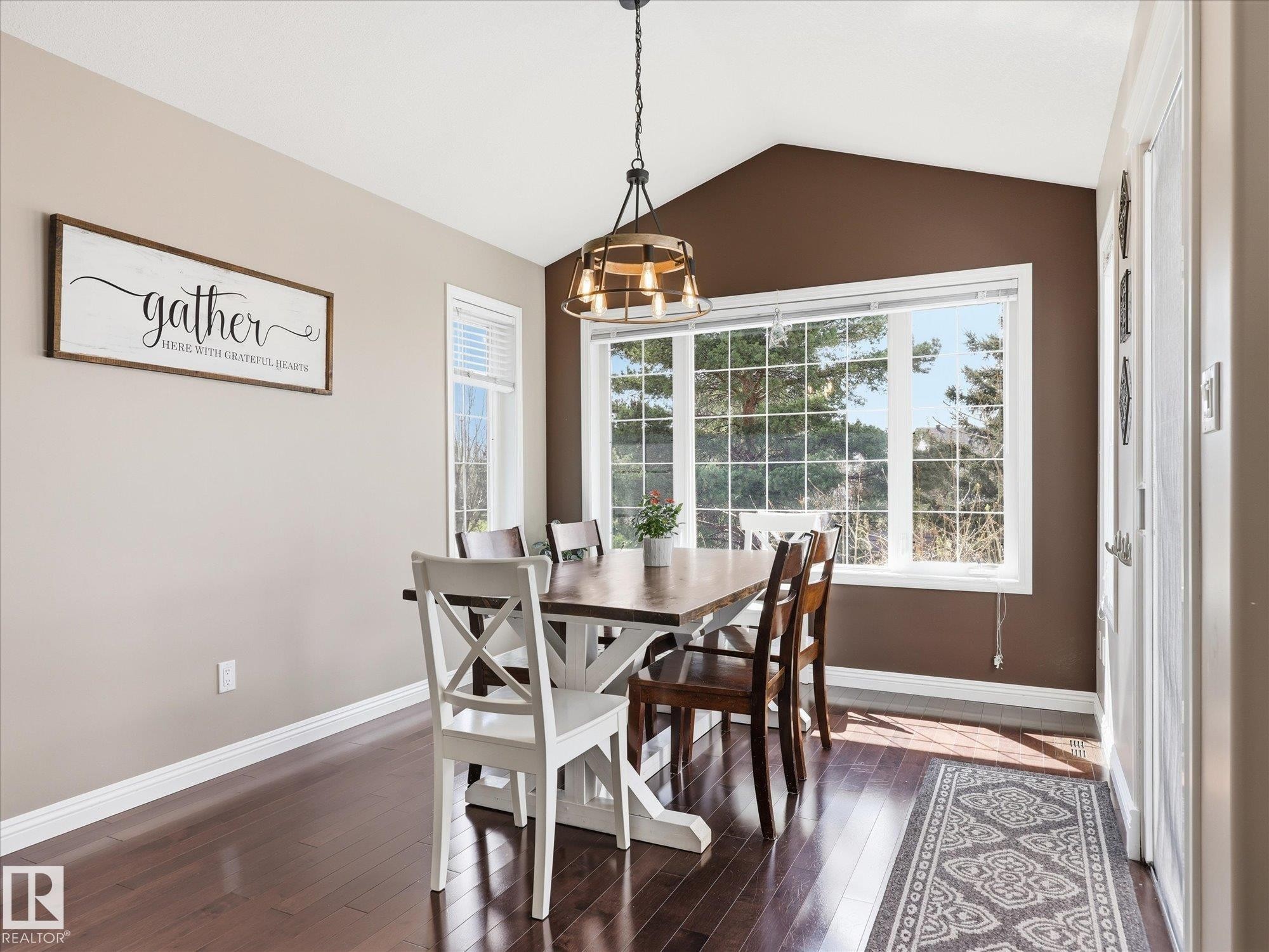 Dining space featuring a vaulted ceiling and dark wood-finish flooring - 1340 Oakland Crescent, Devon, AB - Indoor Photo Showing Dining Room