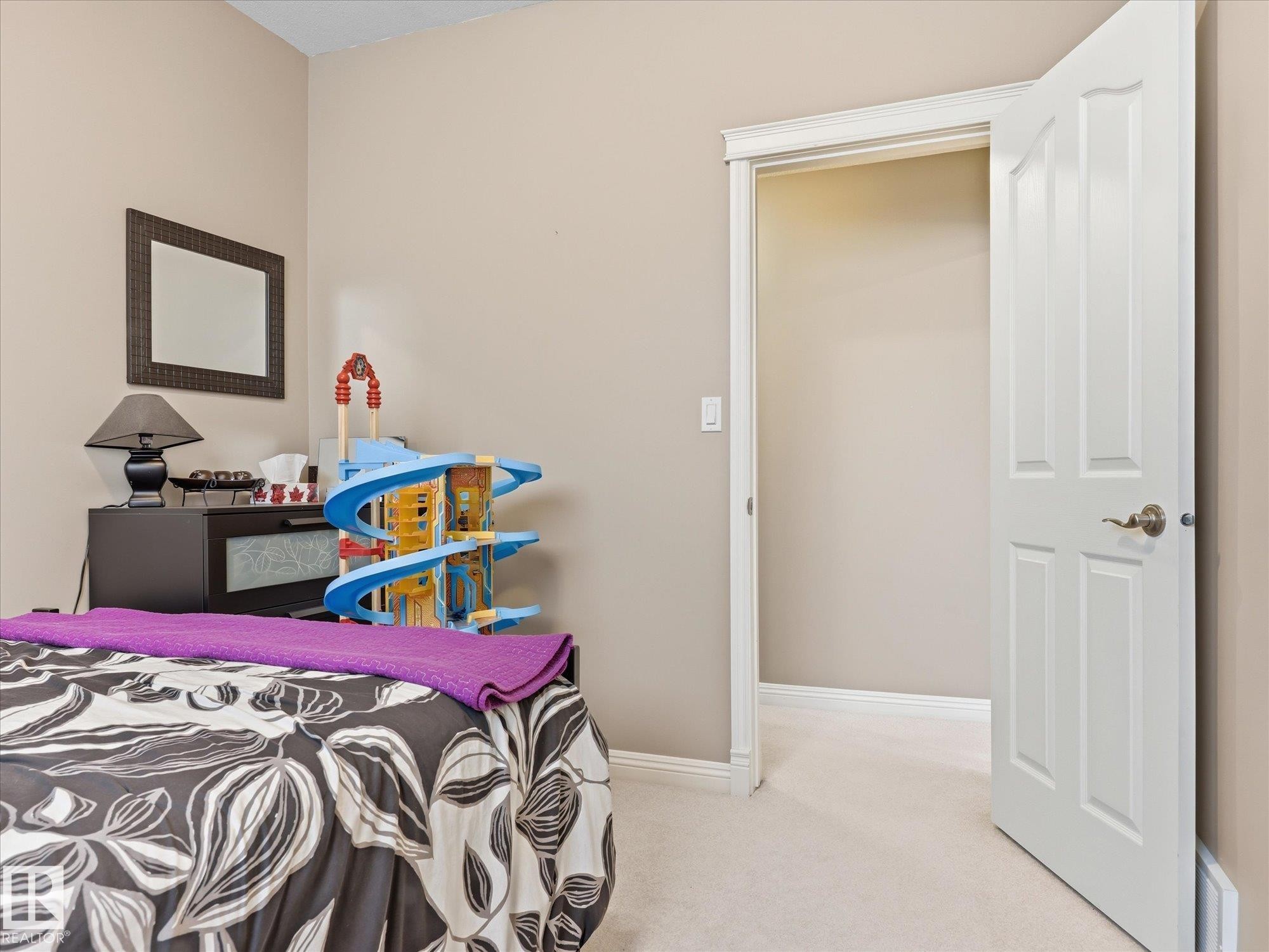 Neutral-toned walls complement plush carpeting throughout this room - 1340 Oakland Crescent, Devon, AB - Indoor Photo Showing Bedroom