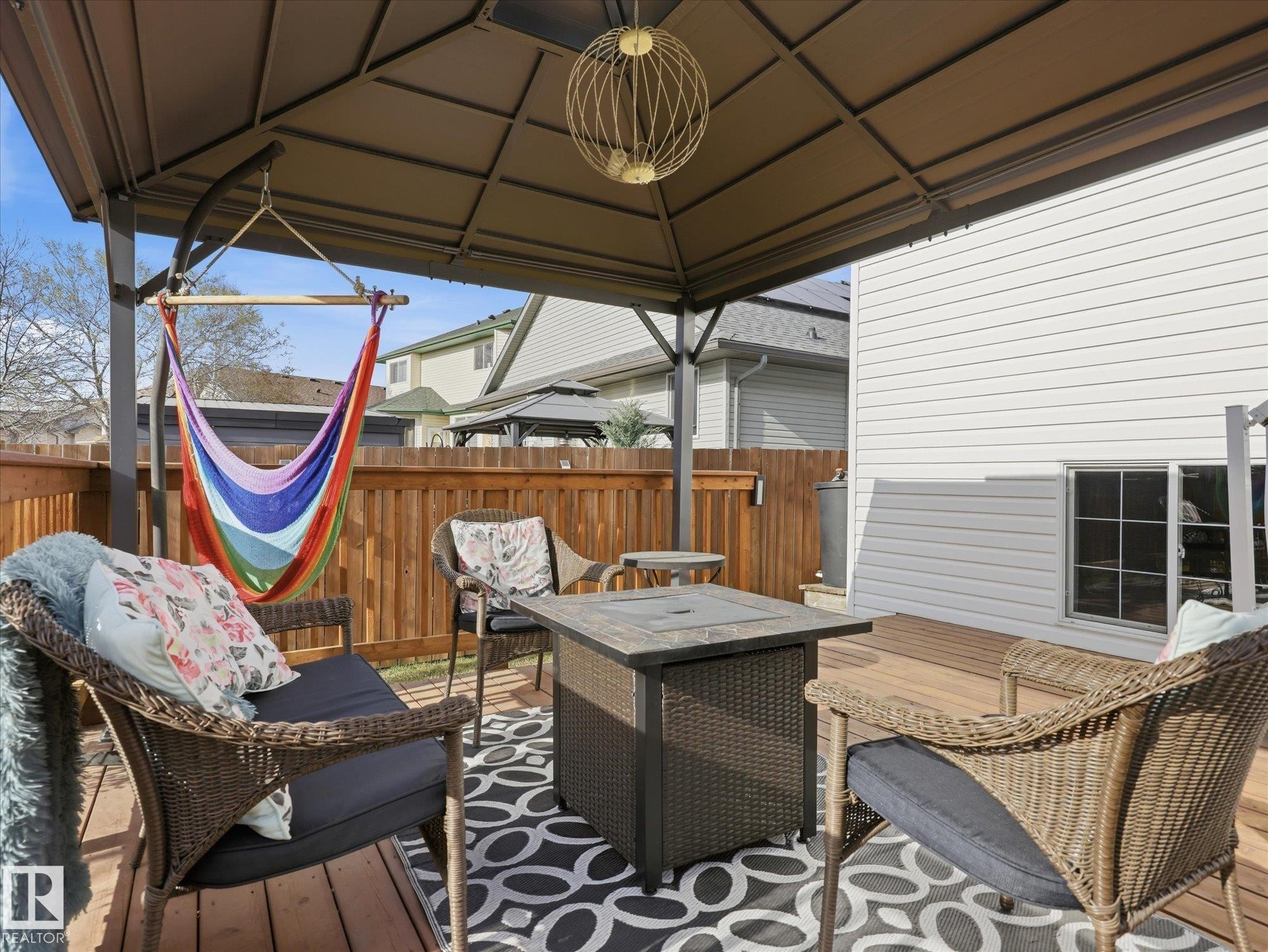 Expansive outdoor deck featuring a fixed gazebo, wood-finish flooring, and a private wooden fence - 1340 Oakland Crescent, Devon, AB - Outdoor With Deck Patio Veranda With Exterior