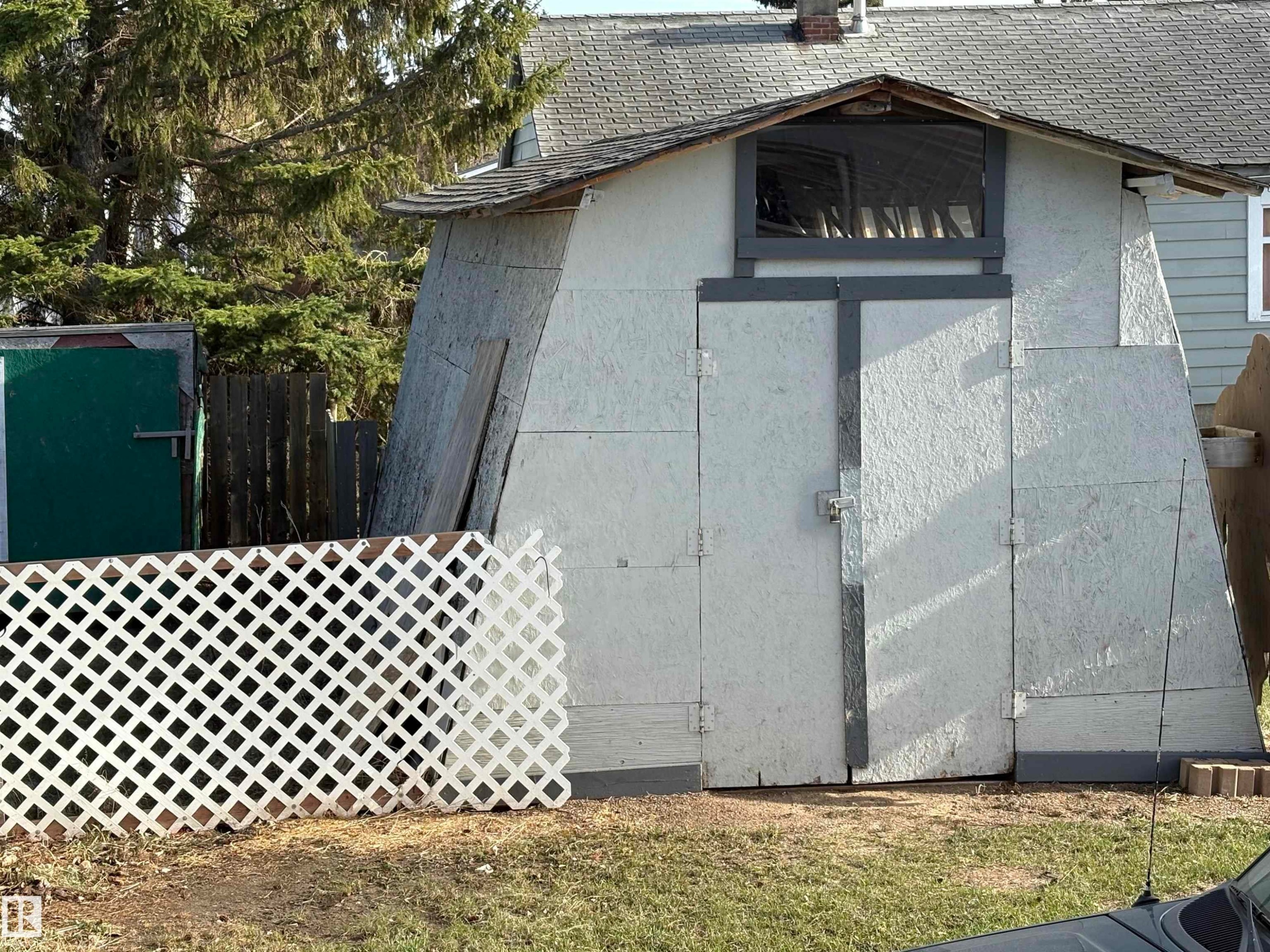 Outbuilding with a peaked roof and a small window above double doors - 115 2Nd Street E, Derwent, AB - Outdoor With Exterior